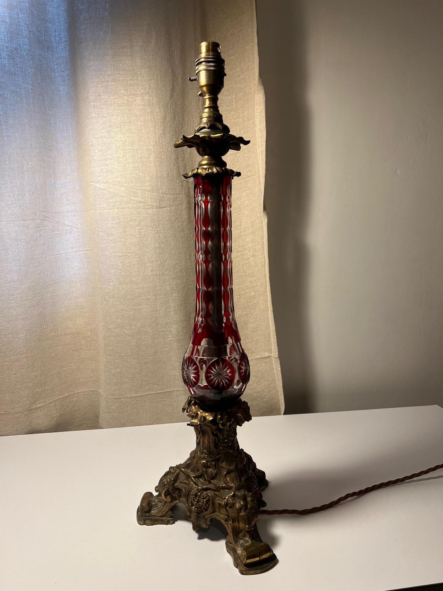 Well cast brass base on a pretty overlay glass top.

Would grace any interior.

Converted from an oil lamp to electric.