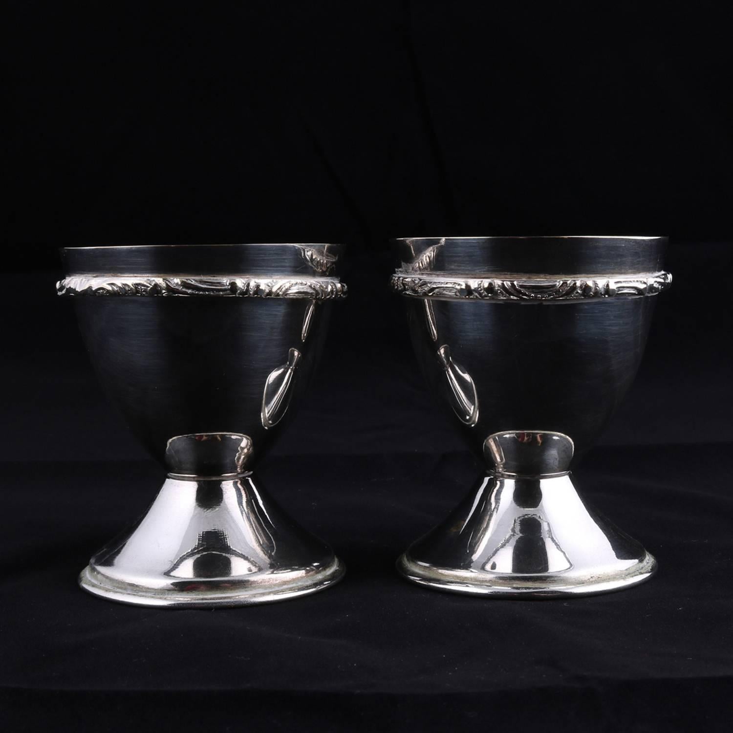 Bohemian pair of Georg Jensen School bride and groom marriage chalice cups feature hourglass form with foliate embossed trimming, silver plate with monograms 