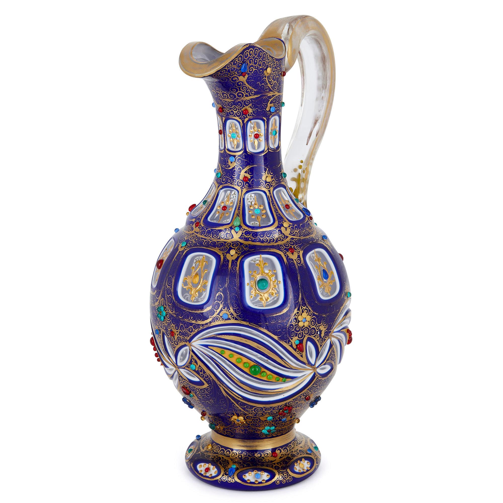 This beautiful glass jug (or ewer) was created in the late 19th century in Bohemia (modern-day Czech Republic). Antique Bohemian glass is prized for the exceptional quality of its craftsmanship and ornamentation. This jug will make a wonderful