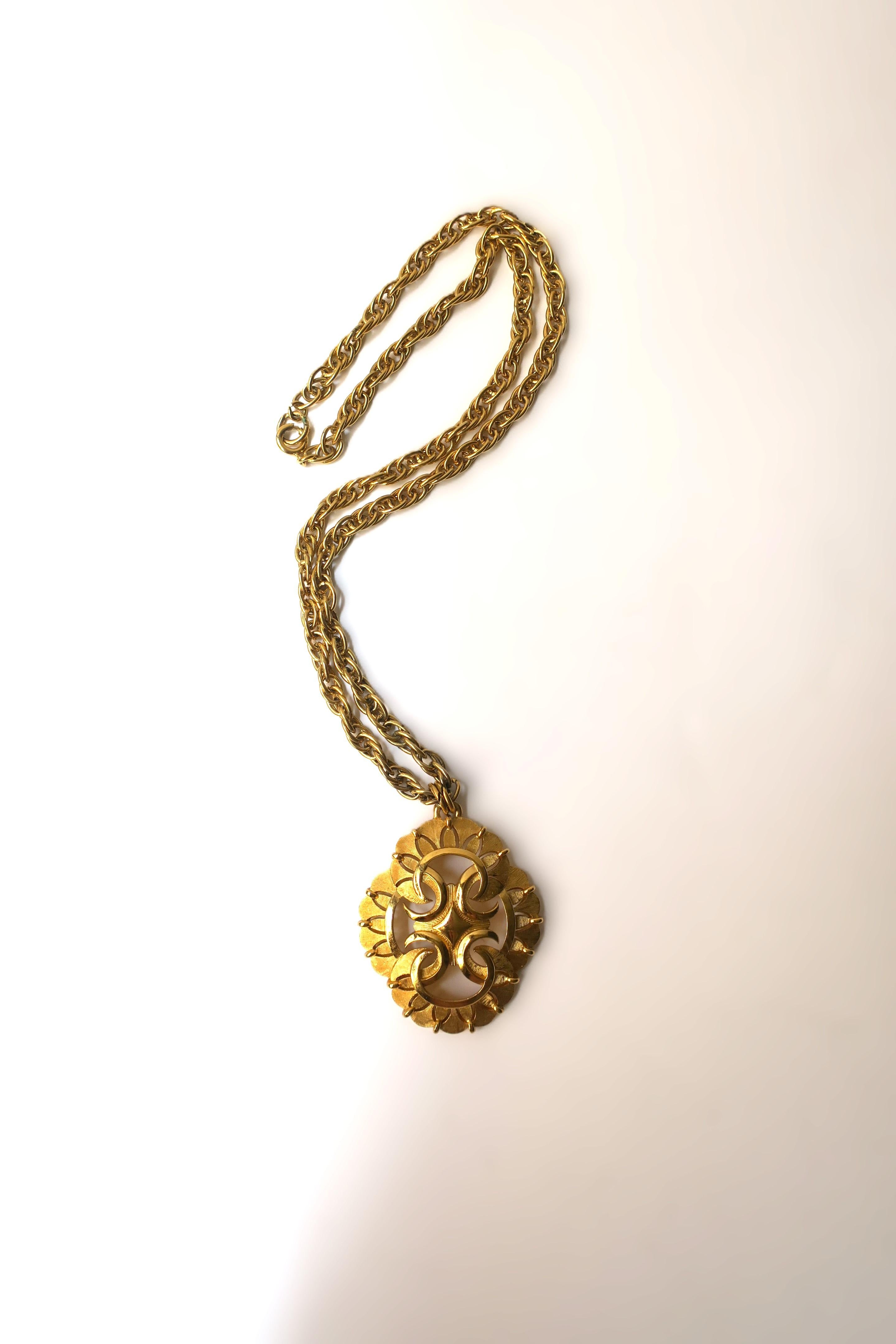 A beautiful 'Crown Trifari' yellow gold-plated rope chain and pendant necklace, by fashion costume jewelry company, Trifari, Bohemian chic, circa 1960s, USA. Beautiful design and craftsmanship, wear this vintage collectable piece with a dress (as