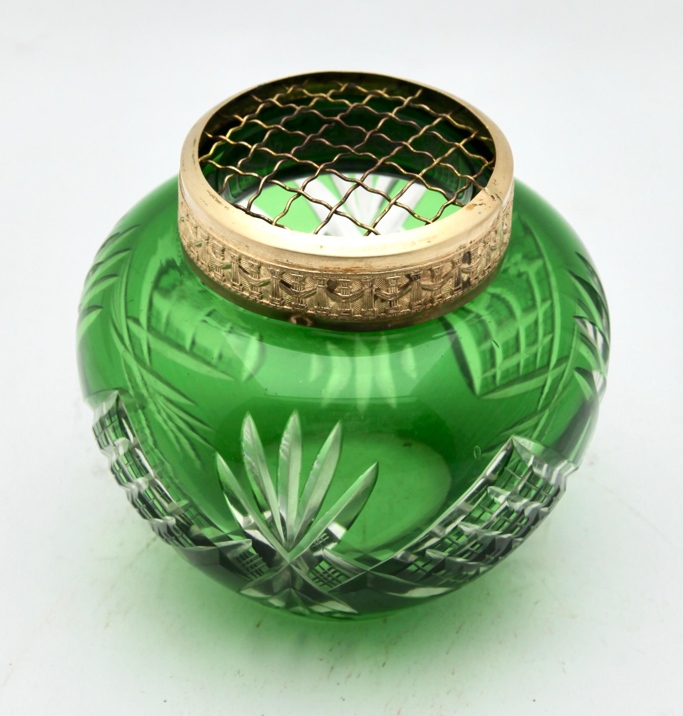 Vibrant, meadow-green cased-crystal glass vase in the Bohemian style with cut-to-clear decoration of palms and trellis. This design for vases is often called 'Pique fleurs' or 'rose-bowl' and is supplied with a fitted metal grille to support stems