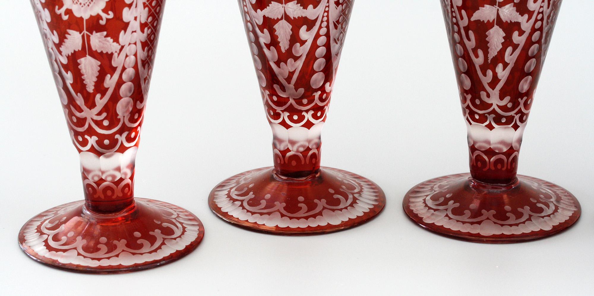 A rare and exceptional quality antique set of six Bohemian ruby flashed cordial glasses with stunning cut and acide etched designs dating from circa 1890. The set, passed down through our owners family, comprises of six glasses of conical shape