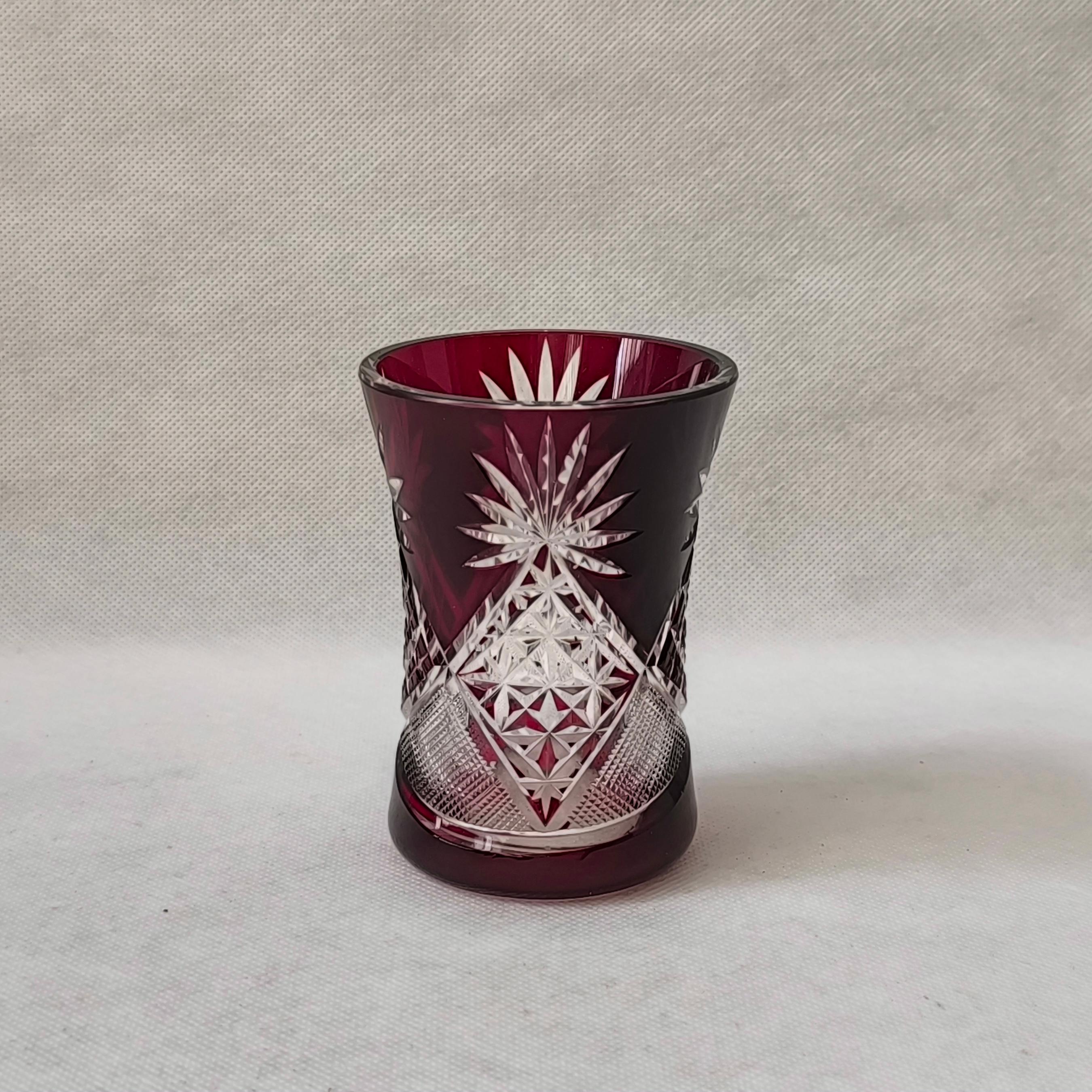 This Bohemian Red Ruby Cut to Clear Crystal Vase is a breathtaking example of traditional European glass artistry. Featuring a rich ruby hue contrasted by precision-cut clear crystal, this vase showcases the timeless elegance and meticulous