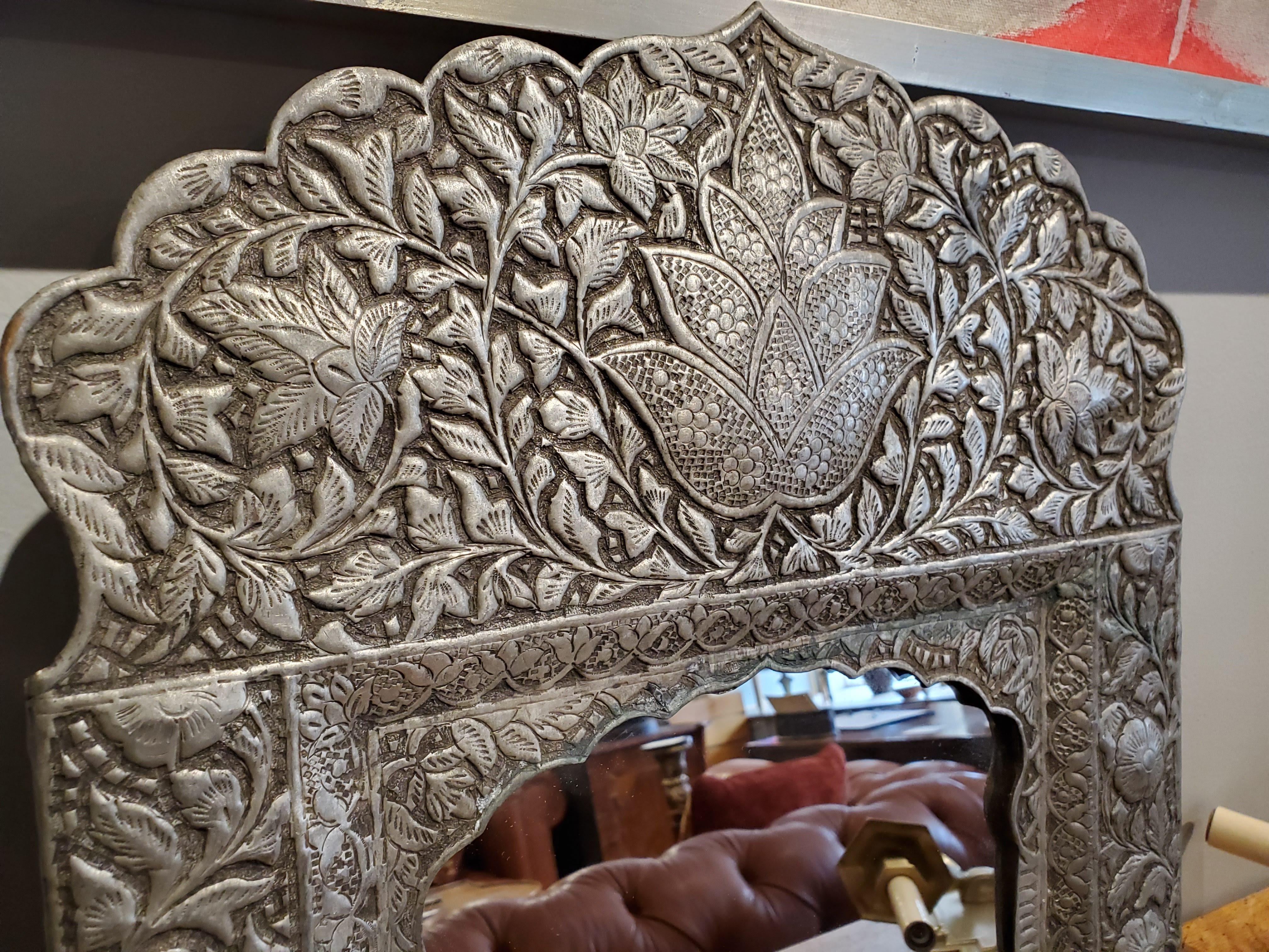 Beautiful mirror for Bohemian inspired design. Intricately hammered and faceted designs with shaped crests over Moorish arches. Great for hallways and small spaces.
Made in India.
Measures: 19