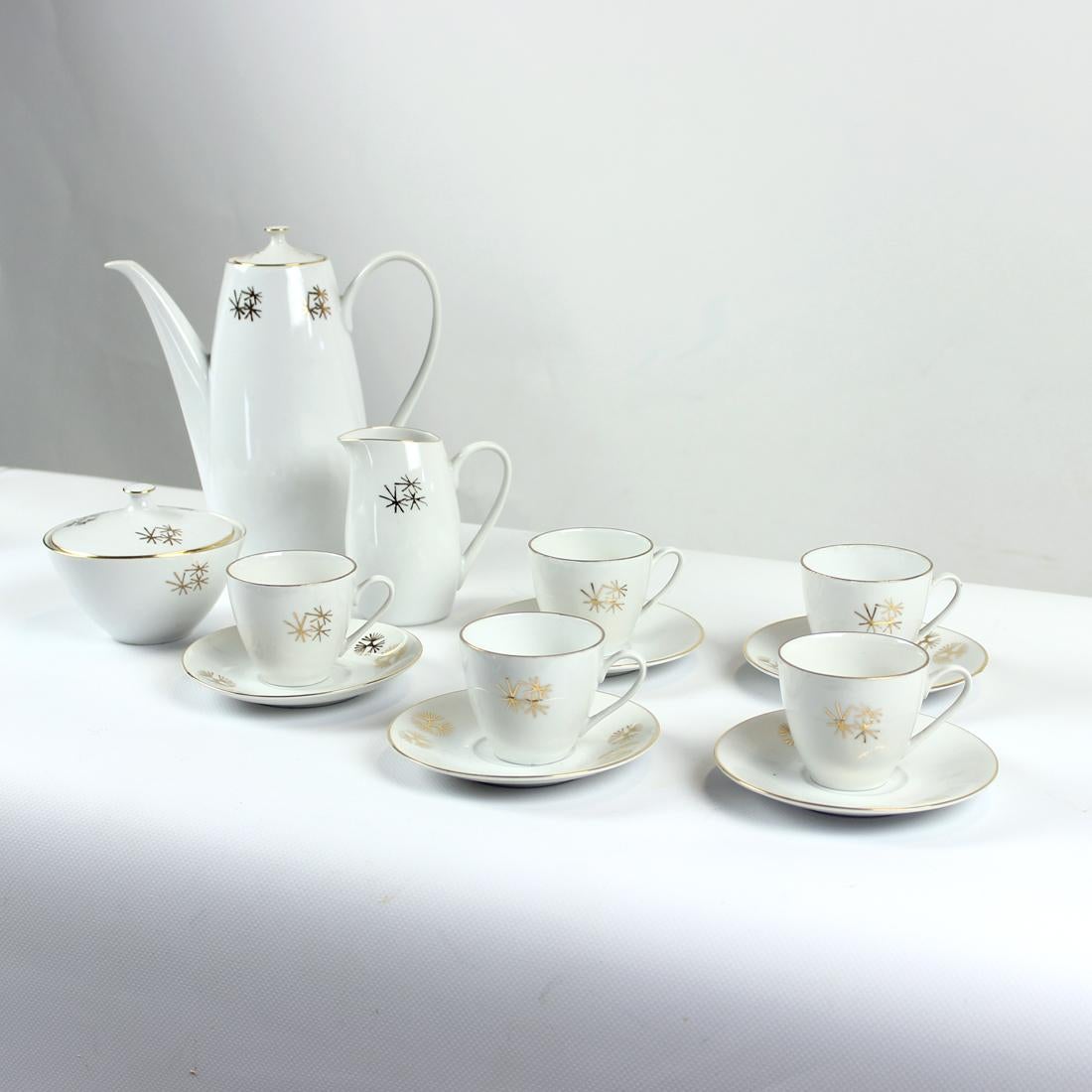 Beautiful tea and coffee set in white porcelain with gold marks as a decoration. Produced in Czechoslovakia in Nova role, original mark still visible. Original catalogue mark aproved by catalogues. The set is trully elegant with typical mid-century