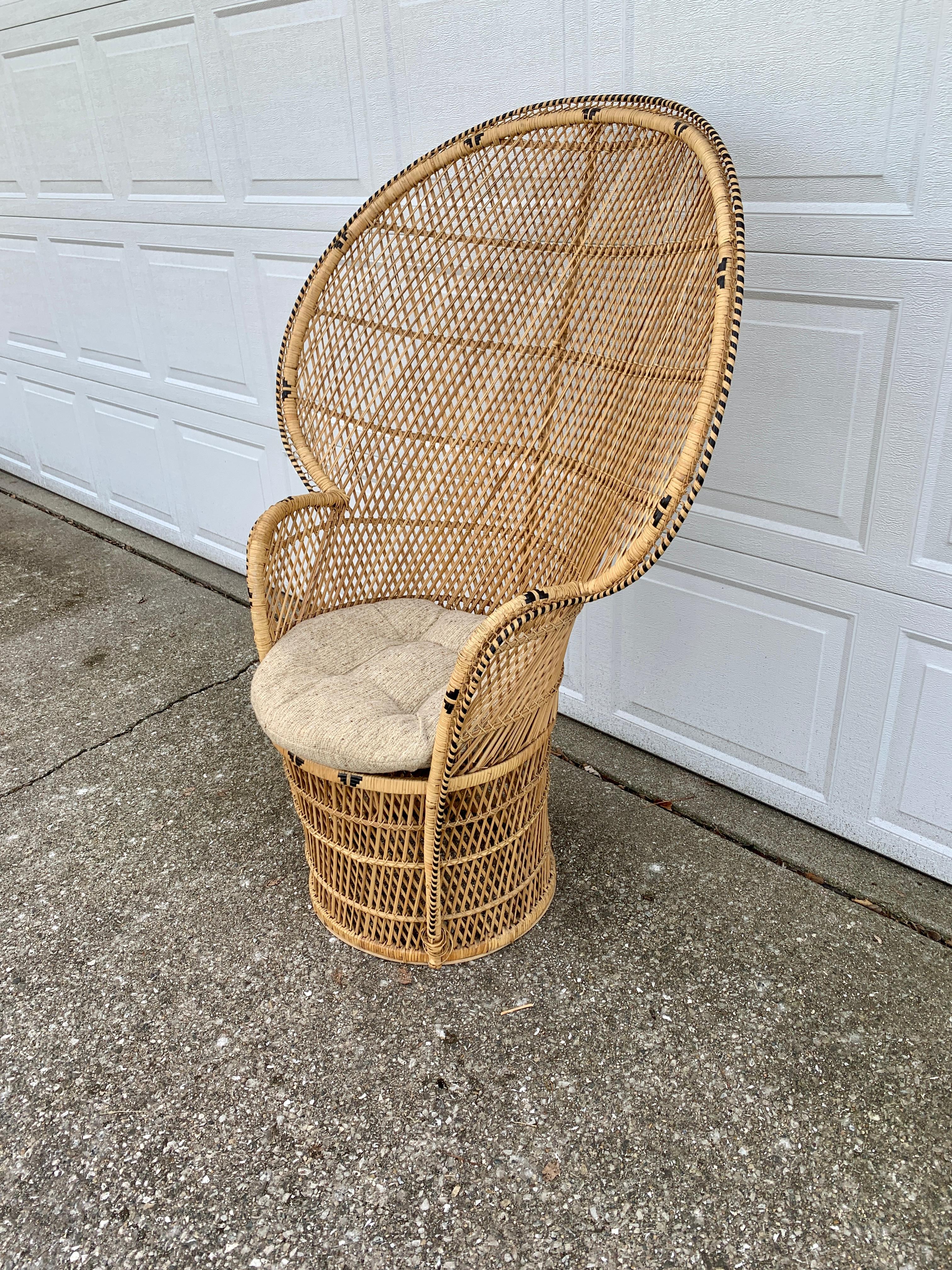 A gorgeous and iconic Mid-Century Modern Bohemian Emanuelle peacock chair??

circa 1970s??

Woven rattan and wicker, with a large-scale fan back.??

Measures: 36.25” W x 21” D x 53” H. Seat height 19