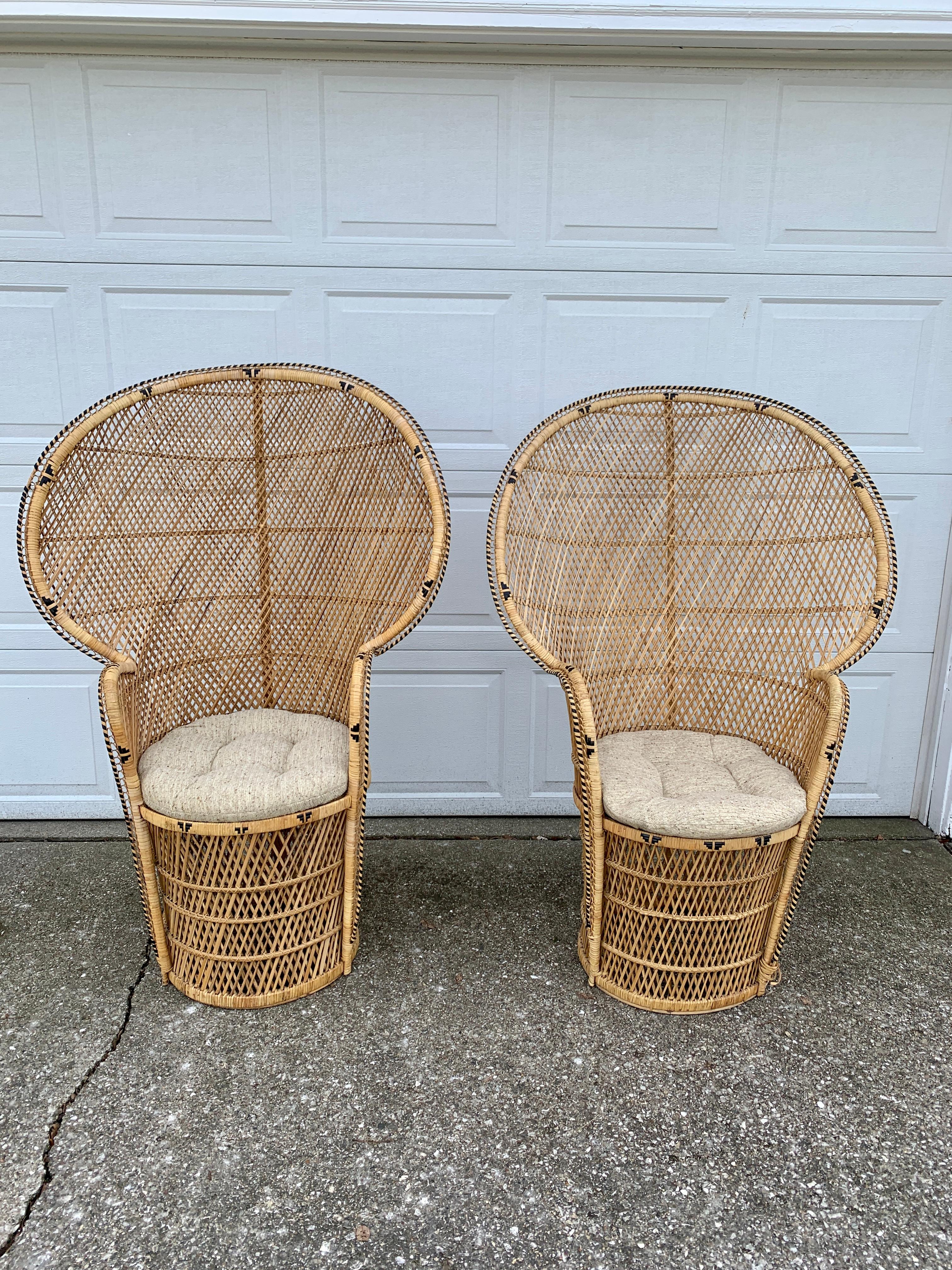 A gorgeous and iconic pair of mid-century modern Bohemian Emanuelle peacock chair??s

Circa 1970s??

Woven rattan and wicker, with a large scale fan back.??

Measures: 36.25”W x 21”D x 53”H. Seat height 19