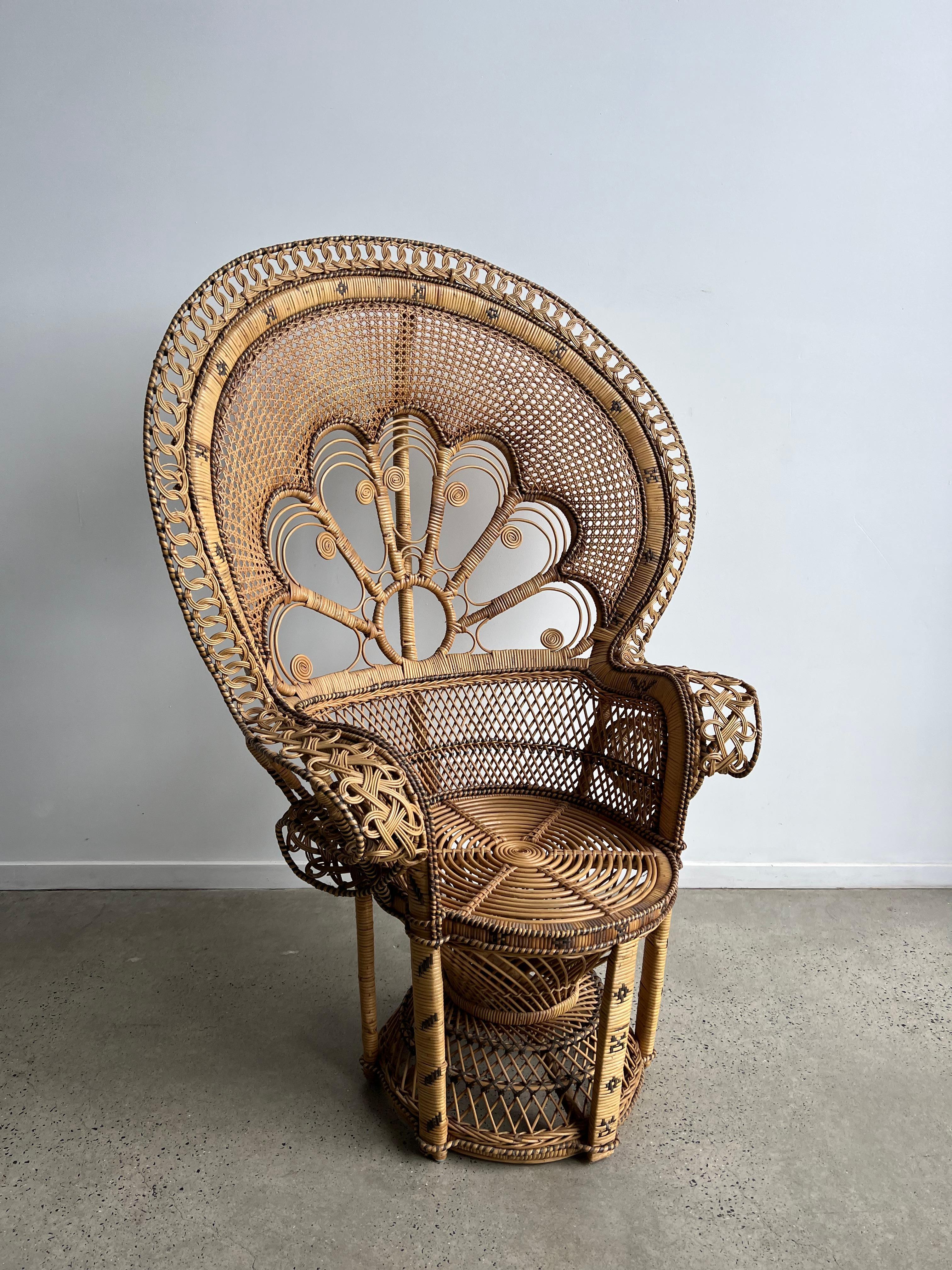 Gorgeous Bohemian-styled peacock chairs made out of woven rattan and wicker. The back features intricate woven detailing, circa 1970s.
The chair features expertly woven wicker and cane with a large-scale fan back, portraying a peacock’s splayed