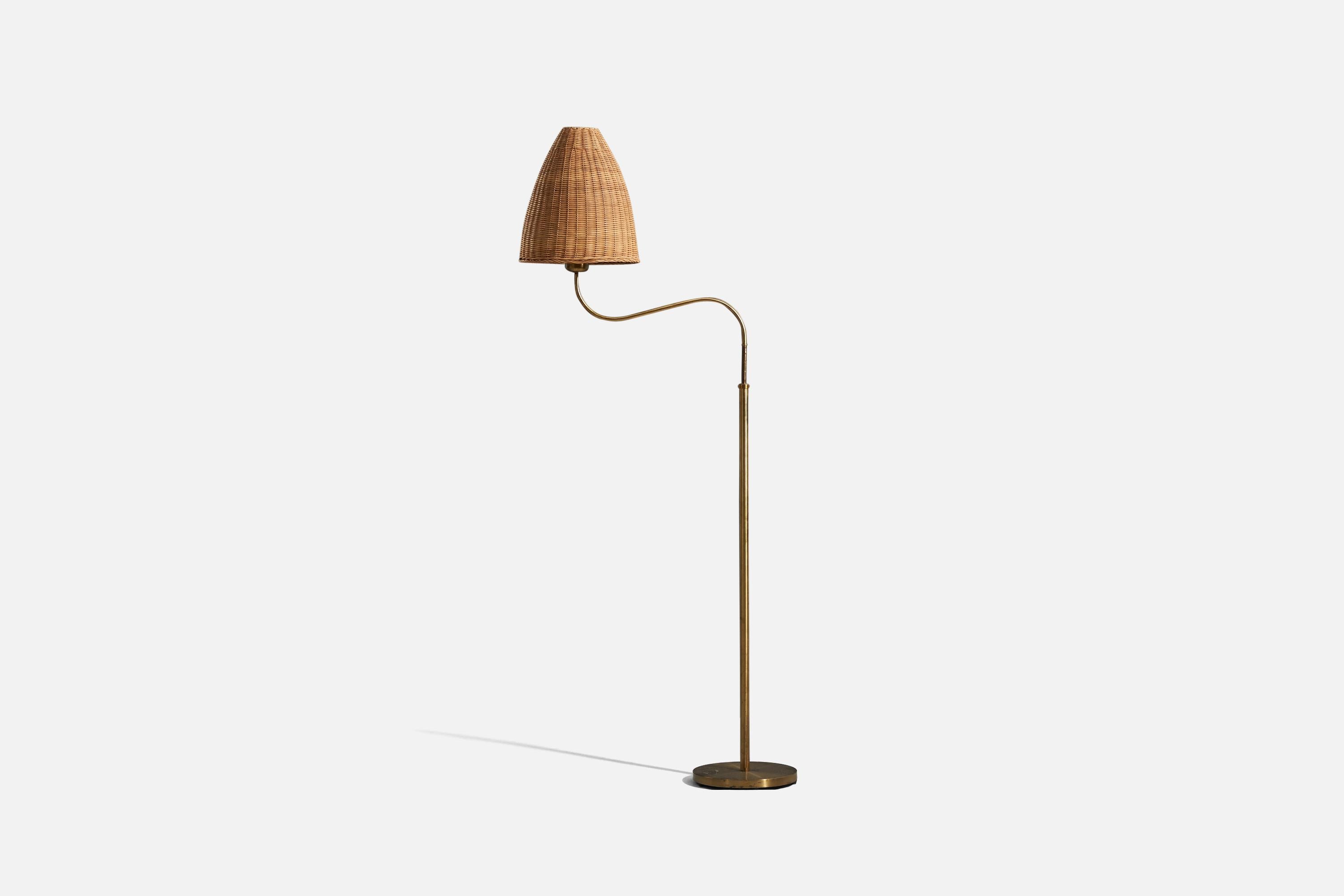 A brass and rattan floor lamp designed by Böhlmarks, Sweden, 1940s. 

Variable dimensions, measured as illustrated in the first image.