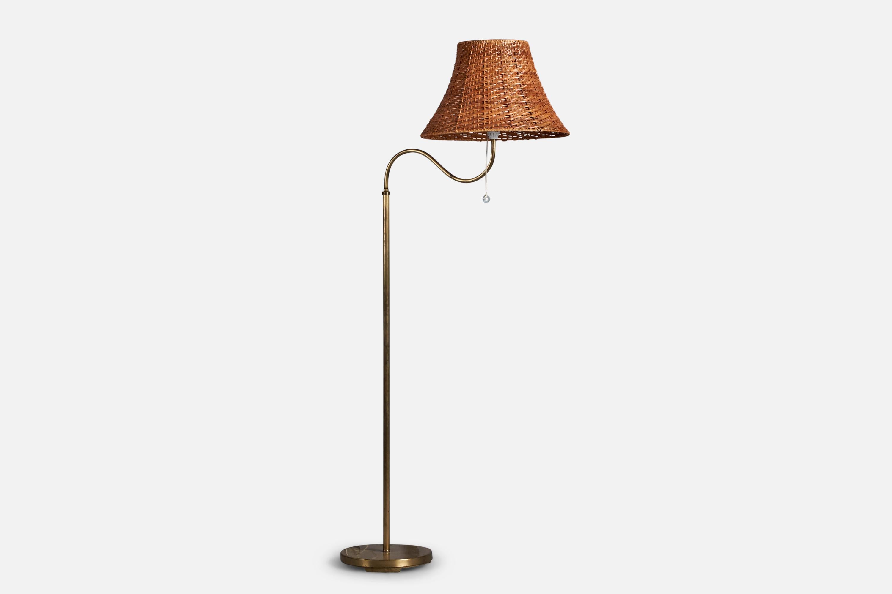 An adjustable brass and rattan floor lamp attributed to Böhlmarks, Sweden, 1940s.

Overall Dimensions (inches): 62” H x 17” W x 30” D
Bulb Specifications: E-26 Bulb
Number of Sockets: 1