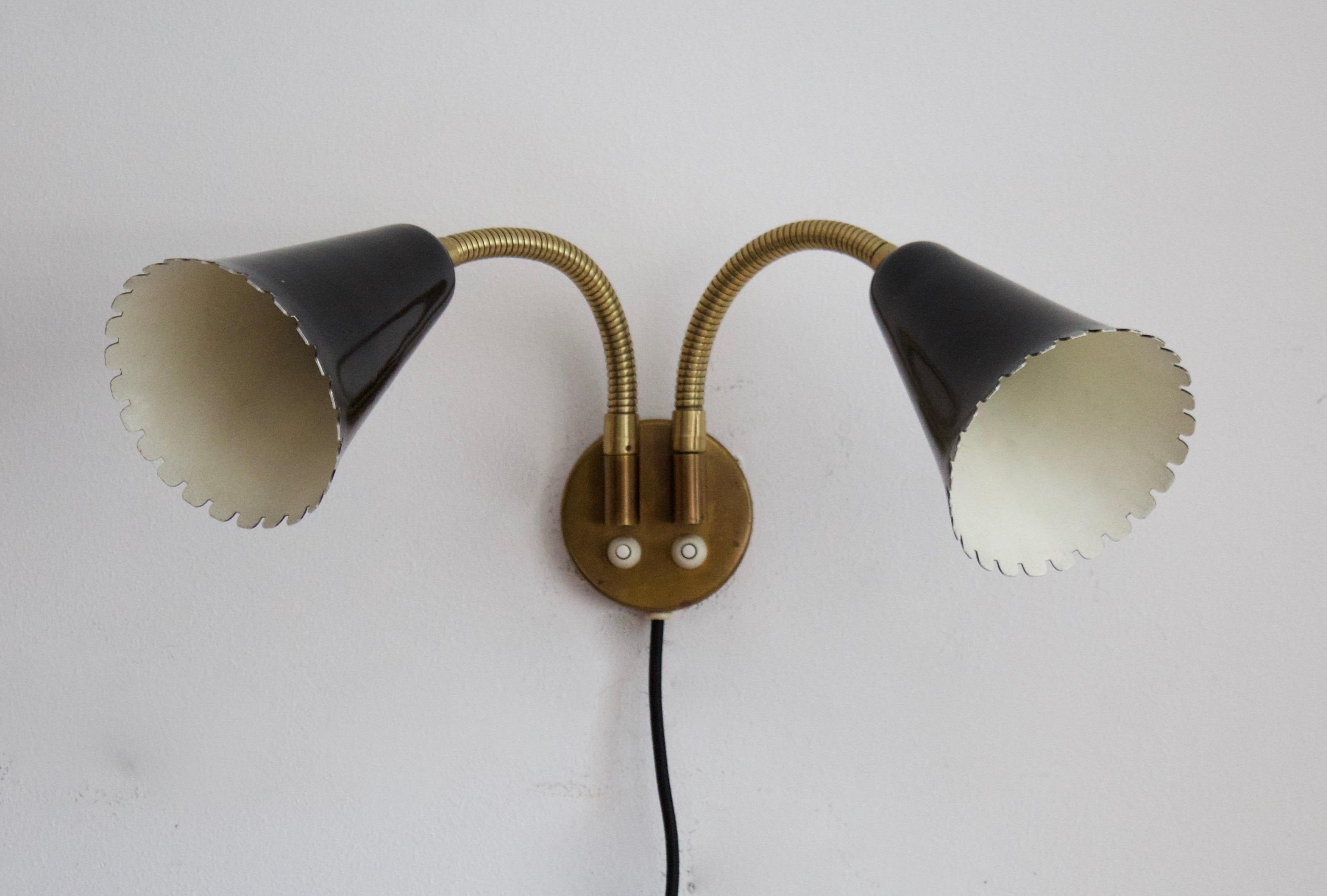 An adjustable organic wall light / sconce. Designed and produced by Böhlmarks, Sweden, 1950s. In brass and black-lacquered metal. Markings indicate patented design. 

Other designers of the period include Jean Royere, Paolo Buffa, Gino Sarfatti,