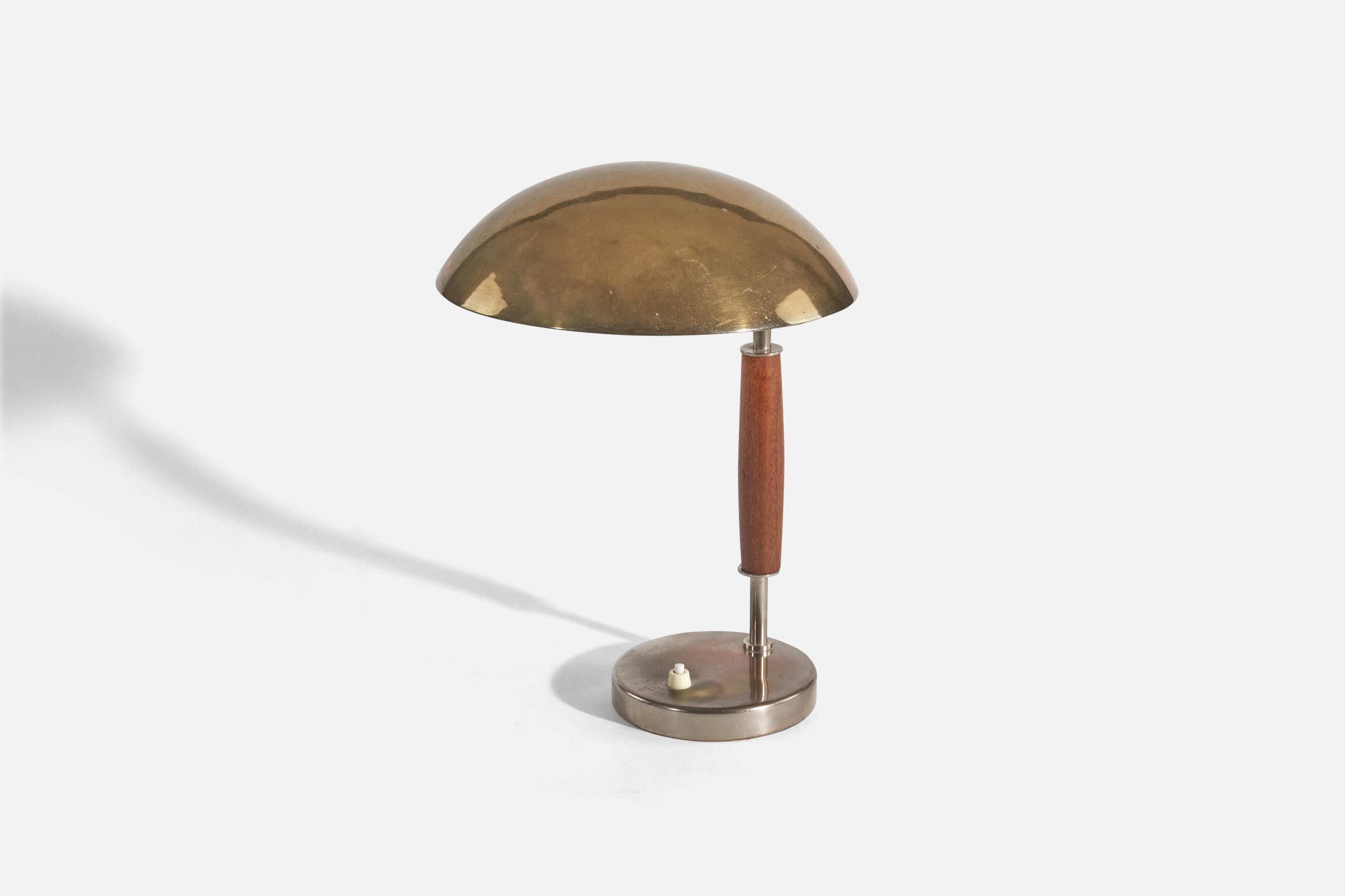 A brass, metal and stained wooden table lamp; design and production attributed to Böhlmarks, Sweden, circa 1940. 

Socket takes standard E-26 medium base bulb.
There is no maximum wattage stated on the fixture.