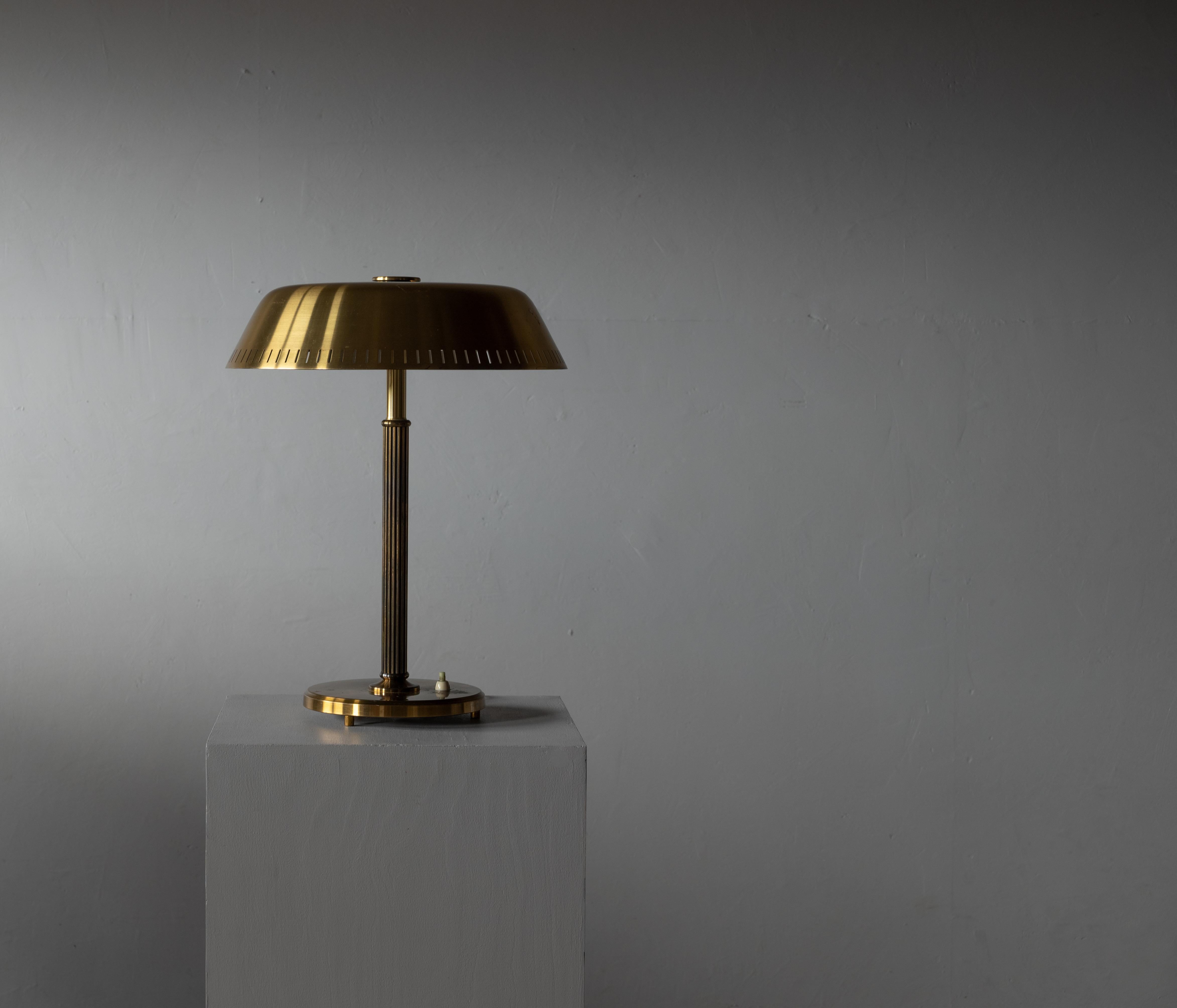 A table lamp. Designed and production attributed to Böhlmarks, Sweden, 1940s. In brass. 

Features fine details such as a perforated lampshade and fluted rod. Brass has retained beautiful patina.

Other designers of the period include Jean