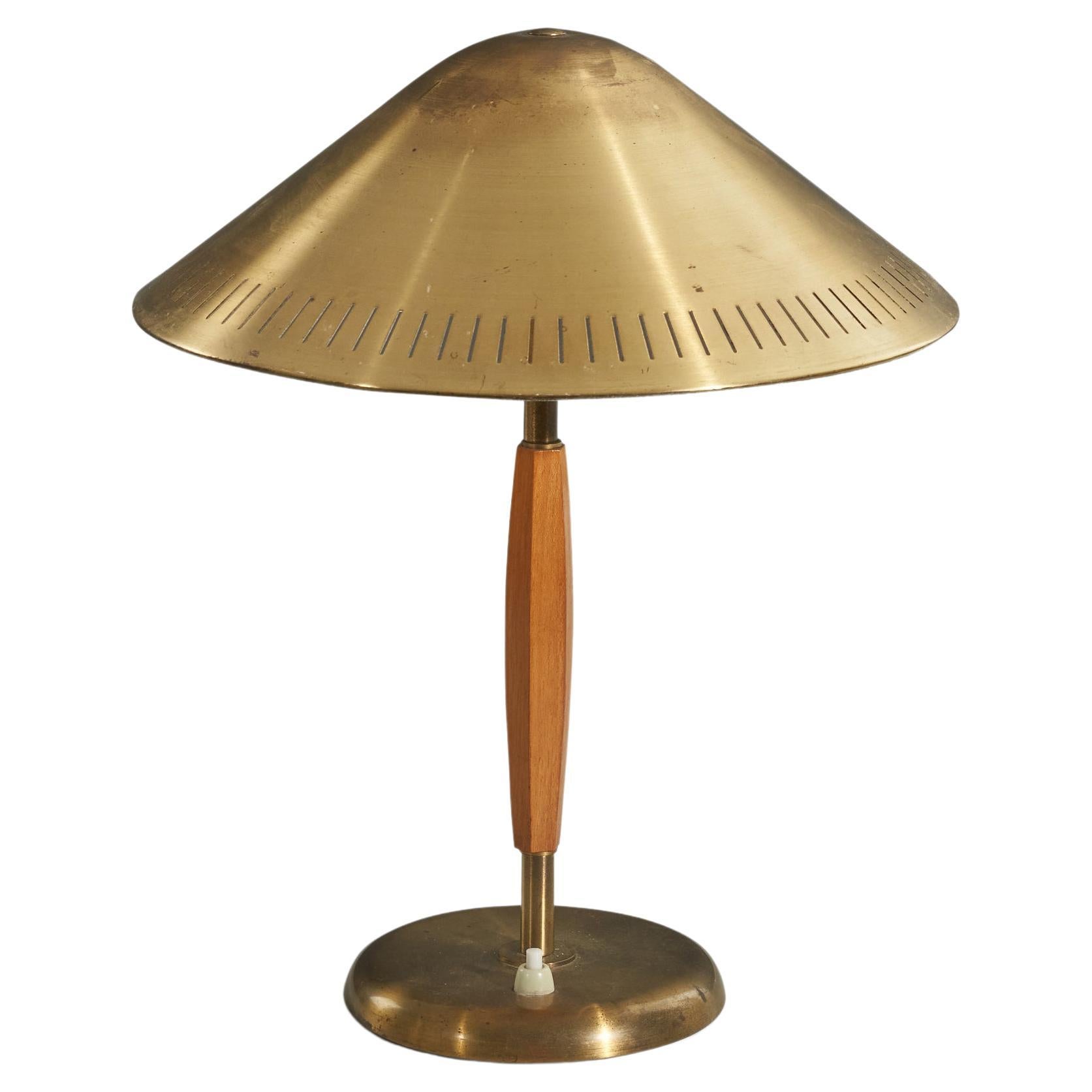 A brass and elm table lamp designed and produced by Böhlmarks, Sweden, 1940s. 

Sold with lampshade. 
Stated dimensions refer to the table lamp with the Shade. 
.