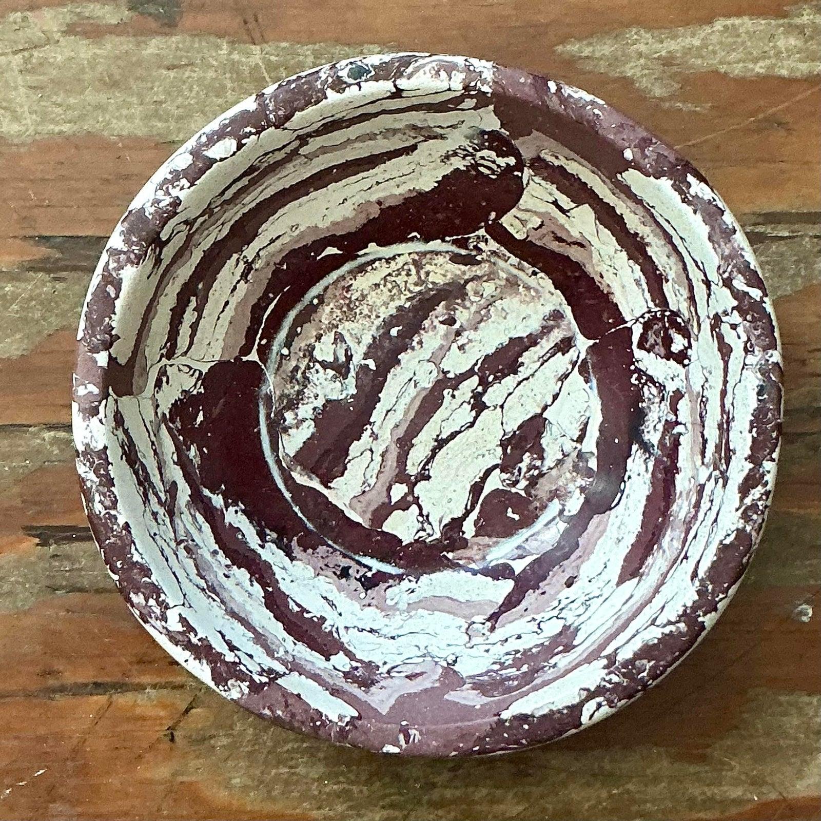 Elevate your tabletop vignettes with this striking Boho Chic scagliola bowl, a captivating example of artistic craftsmanship. Featuring a mesmerizing hand-painted marbled design in earthy tones of deep terracotta, rust, and cream, this piece