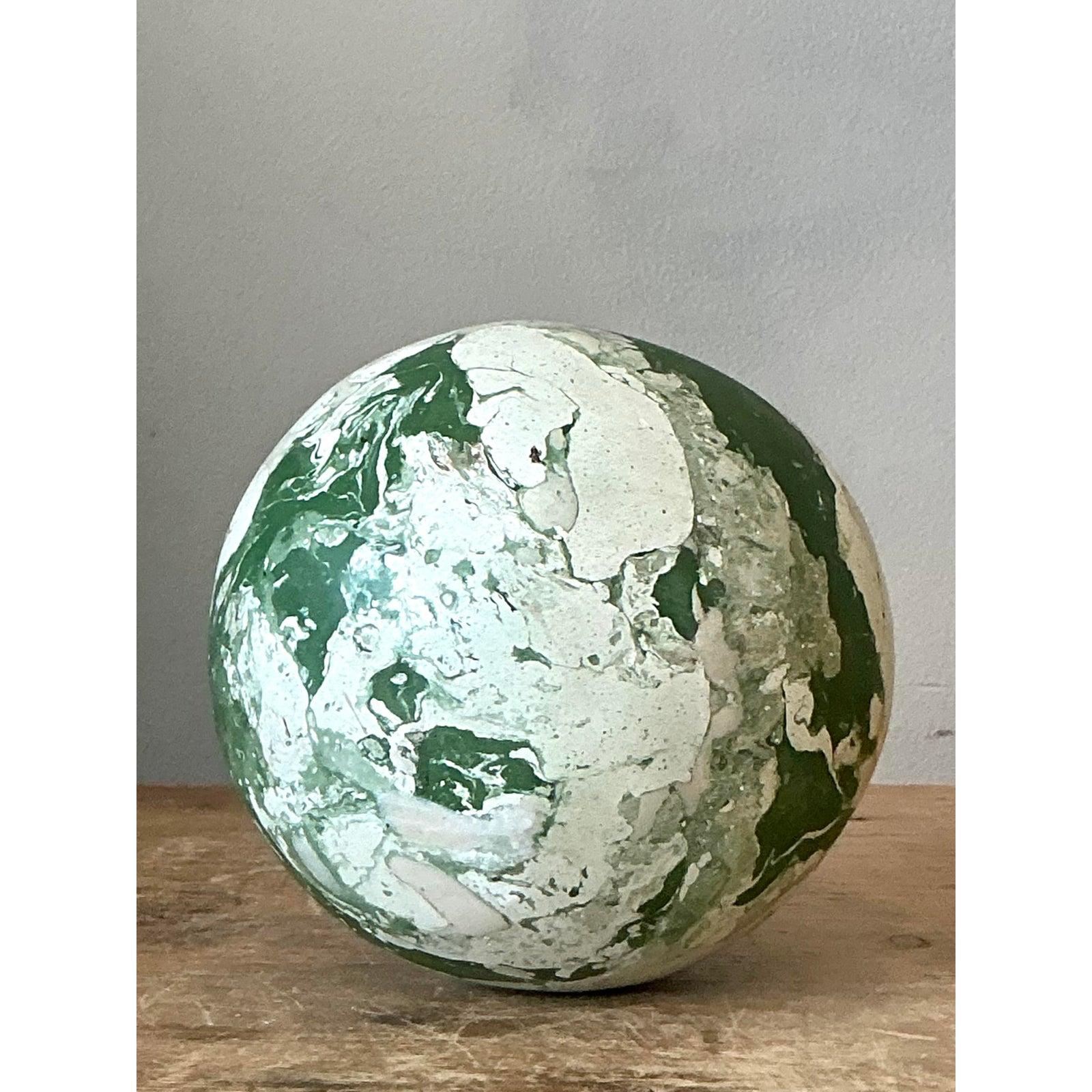 Introduce a touch of earthy, artisanal elegance to your home with this captivating scagliola sphere. Expertly crafted using the traditional scagliola pigmented plaster technique to mimic the weight and appearance of natural stone, this orb features