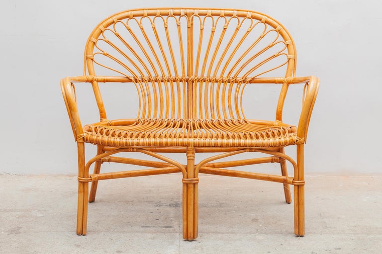 Vintage mid-century Boho set of bamboo wicker two seater in excellent condition with coffee table in bamboo and glass top.
Dimensions:Two-seater: 110W x 92H x 62D cm Seat: 42 cm high / Coffee-table:49W x 53H cm.
 