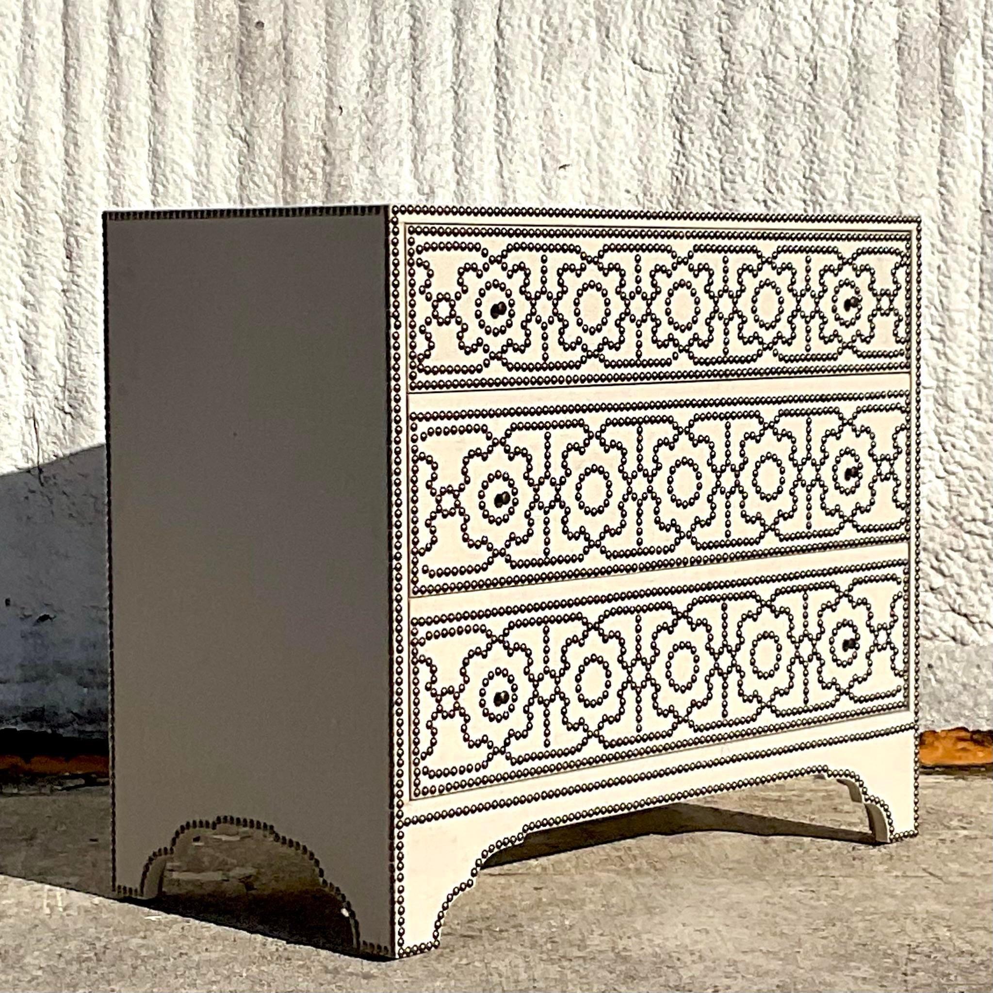 A fabulous vintage Contemporary chest of drawers. Made by the Bernhardt group and tagged inside the drawer. A beautiful linen wrapped cabinet with chic Moorish nailhead trim on the drawer fronts. Acquired from a Palm Beach estate.