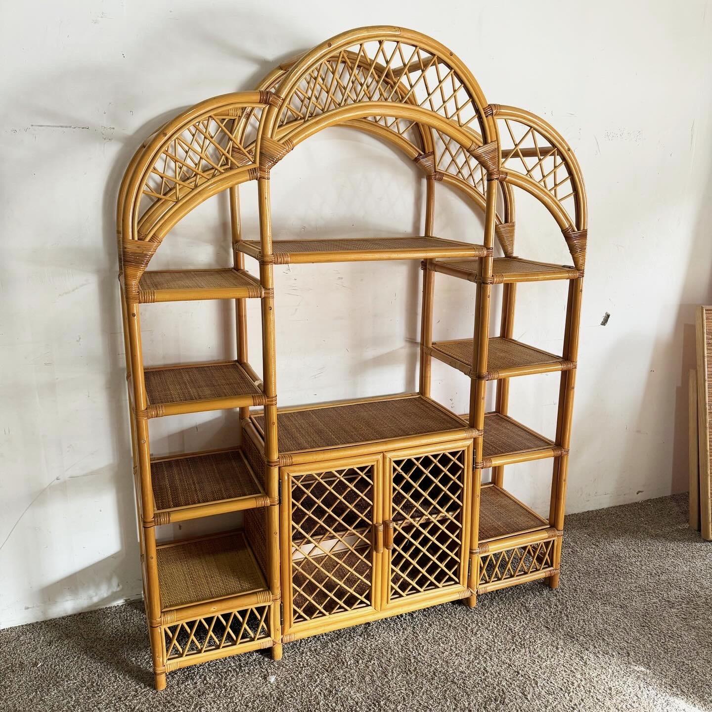 Embrace the natural charm of this Boho Chic Arched Bamboo Rattan and Wicker Etagere. Its architectural arched top and blend of bamboo, rattan, and wicker create a stunning display piece. Offering multiple shelves for books, plants, or decor, it's