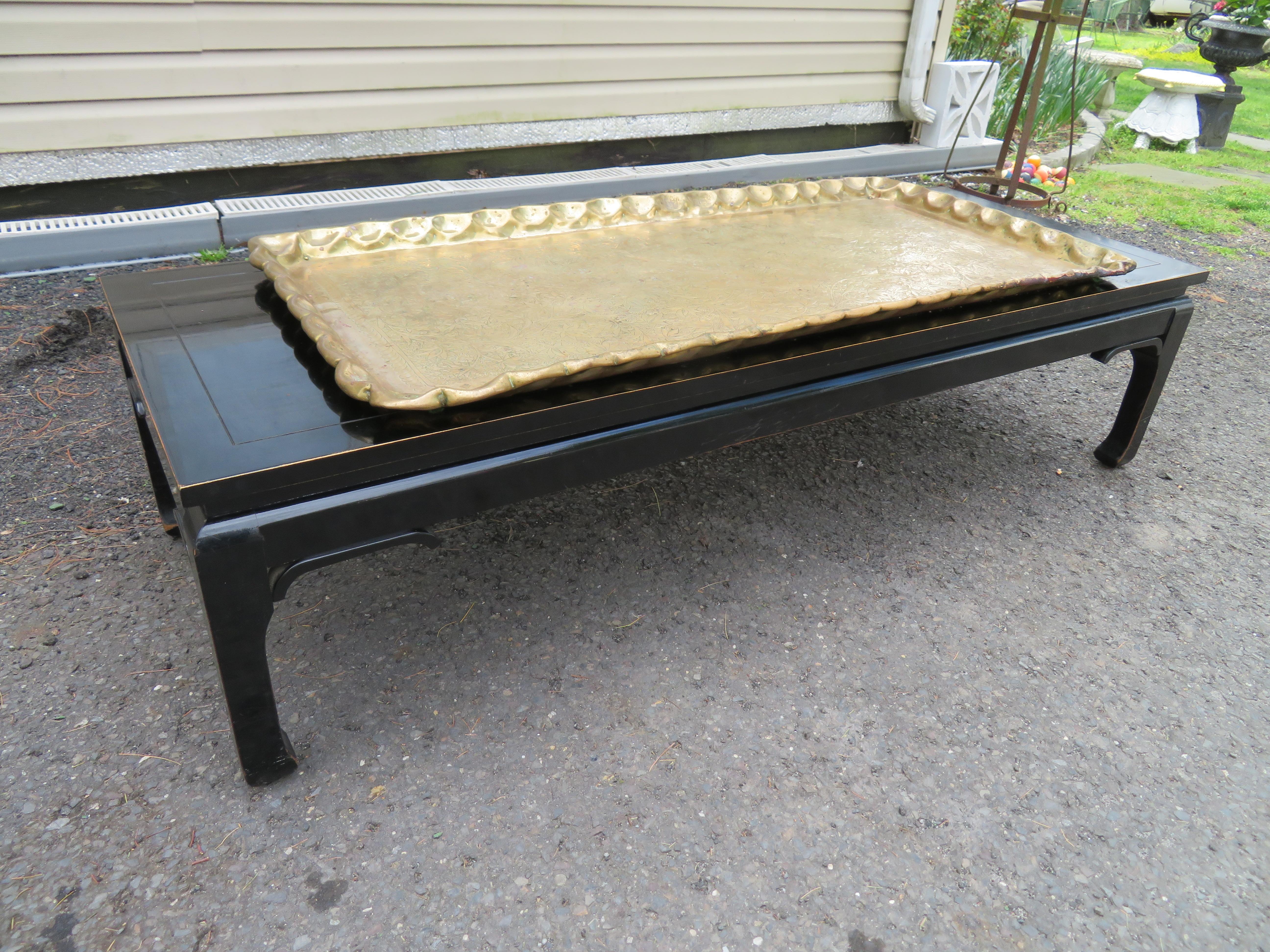 Charming Boho Chic Asain style black lacquered coffee table with attached brass tray. We love the heavy brass tray with its rich patina and the vintage charm of the black lacquered coffee table. This table has tremendous vintage appeal with a