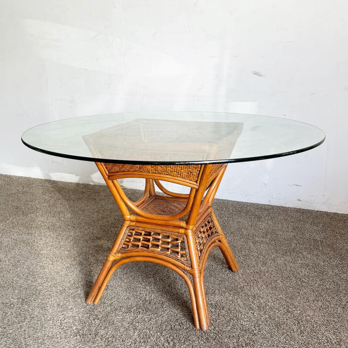 Experience a blend of natural elegance and contemporary style with the Boho Chic Bamboo and Rattan Glass Top Dining Table. Featuring a bamboo and rattan base and a modern clear glass top, this table is a perfect centerpiece for any dining setting.
