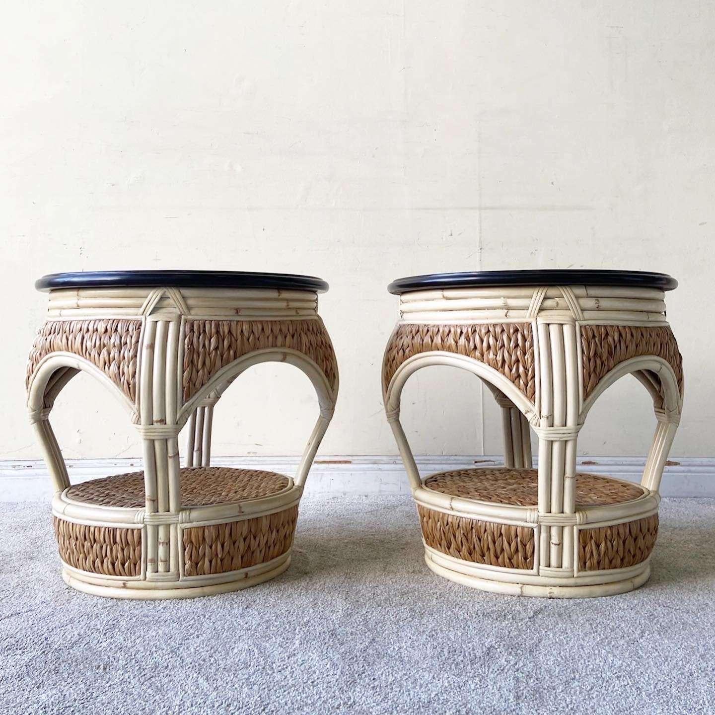 Exceptional pair of vintage boho chic circular side tables. Each feature a a wooden top with a painted cream bamboo frame and sea grass paneling.