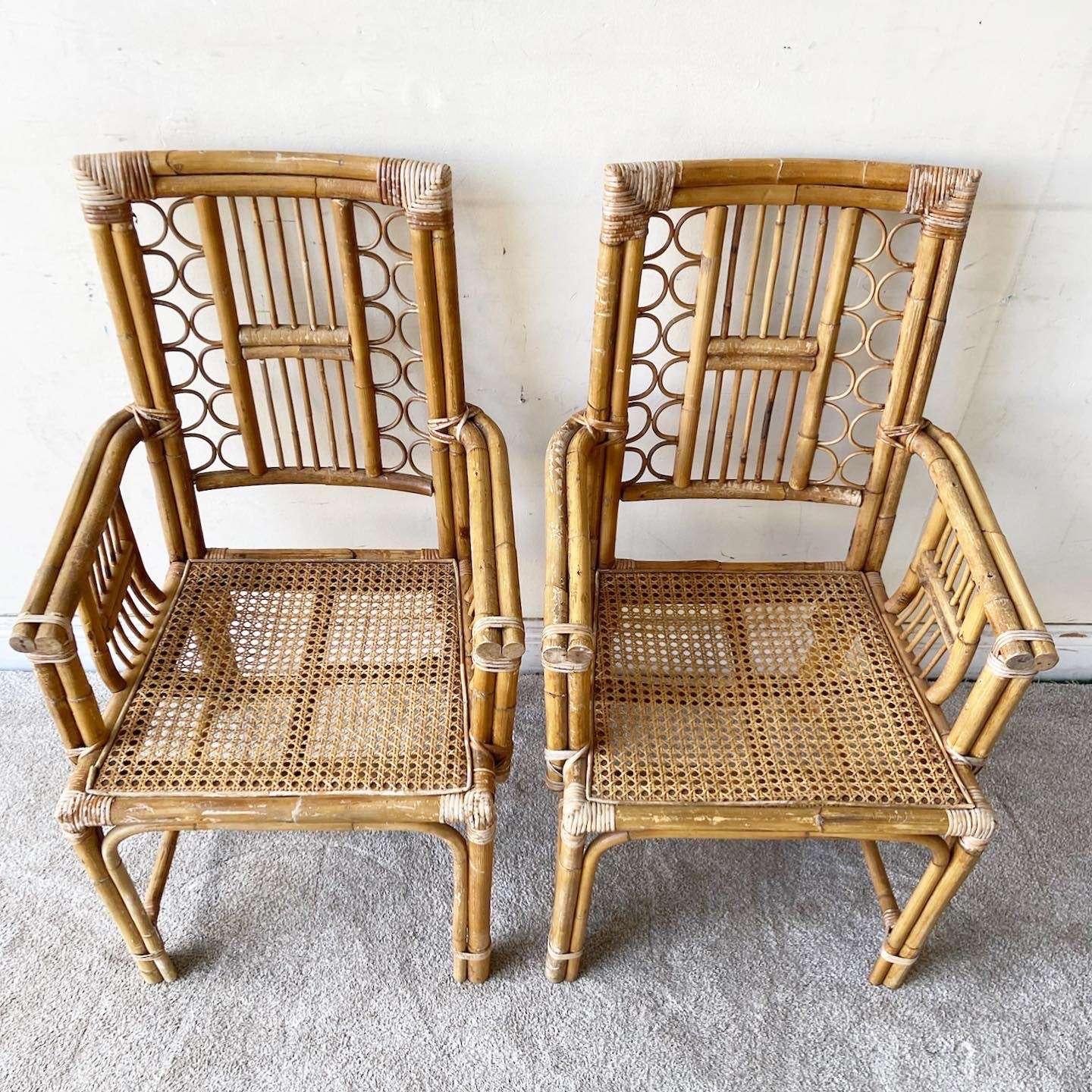 Phenomenal pair of vintage bohemian bamboo and rattan dining chairs. Each feature a can seat with a fretted back rest.

Seat height is 17.0 in