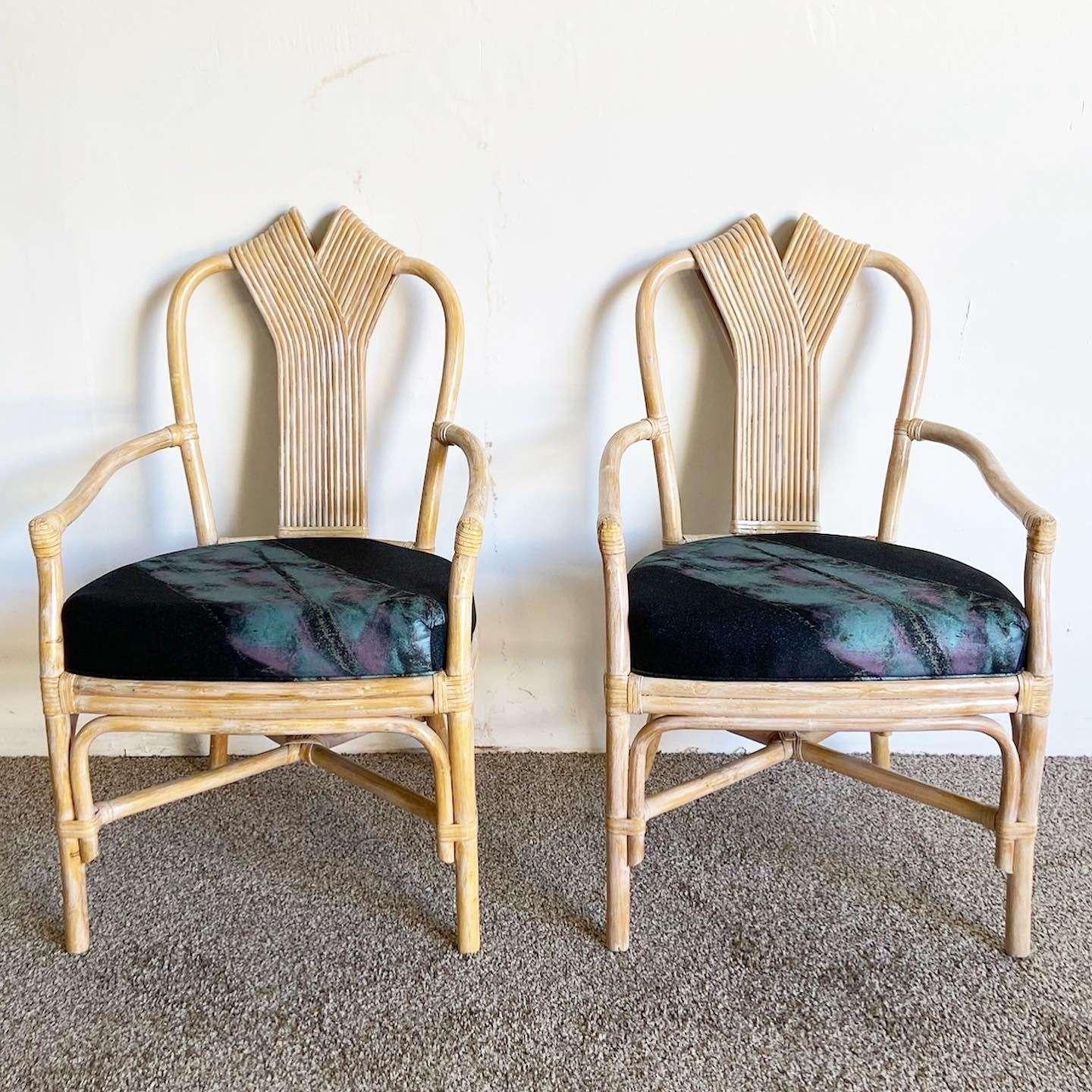 Amazing set of 6 vintage bohemian bamboo rattan dining chairs. Each feature a washed finish with a sculpted reed ribbon back rest. The cushions are black with a postmodern, 80s style pink and blue fabric. 