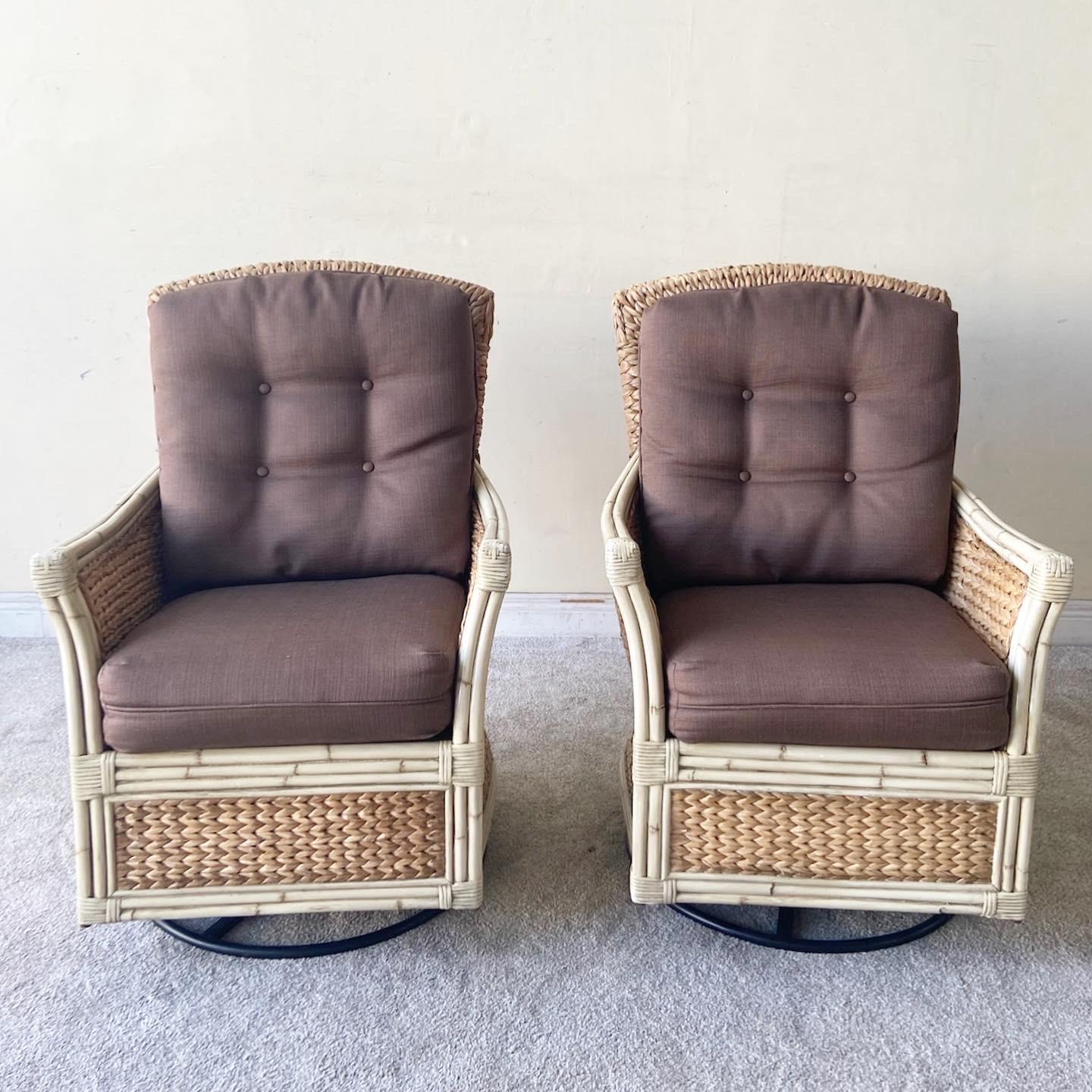 Amazing vintage handmade bohemian rocking swivel chairs. Each feature a painted cream bamboo and rattan frame with woven sea grass through out the chairs.