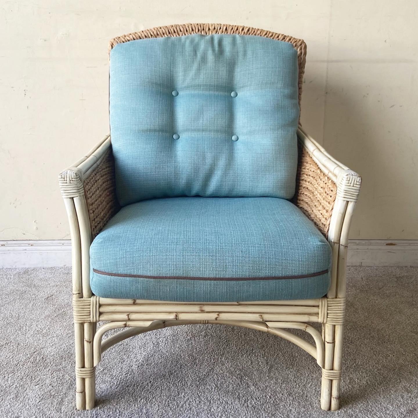 Exceptional vintage bohemian lounge chair with matching ottoman. Each feature a painted bamboo and rattan frame with hand woven seagrass through the pieces and blue cushions.

Foot rest measures 25”W, 18.5”D, 16.5”H.