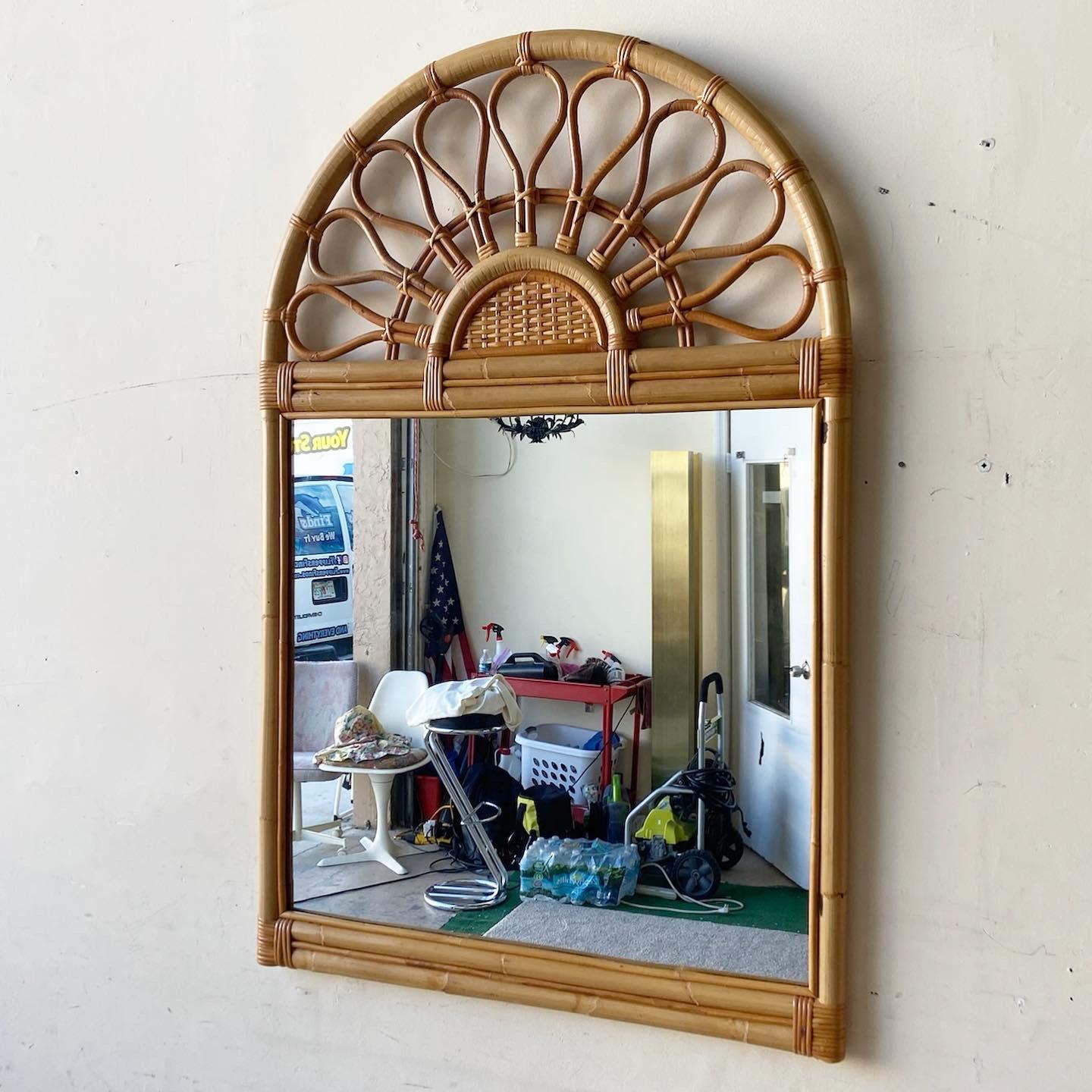 Incredible vintage bohemian bamboo rattan wall mirror. Features wicker accents with bent bamboo arching over the top of the frame.
  