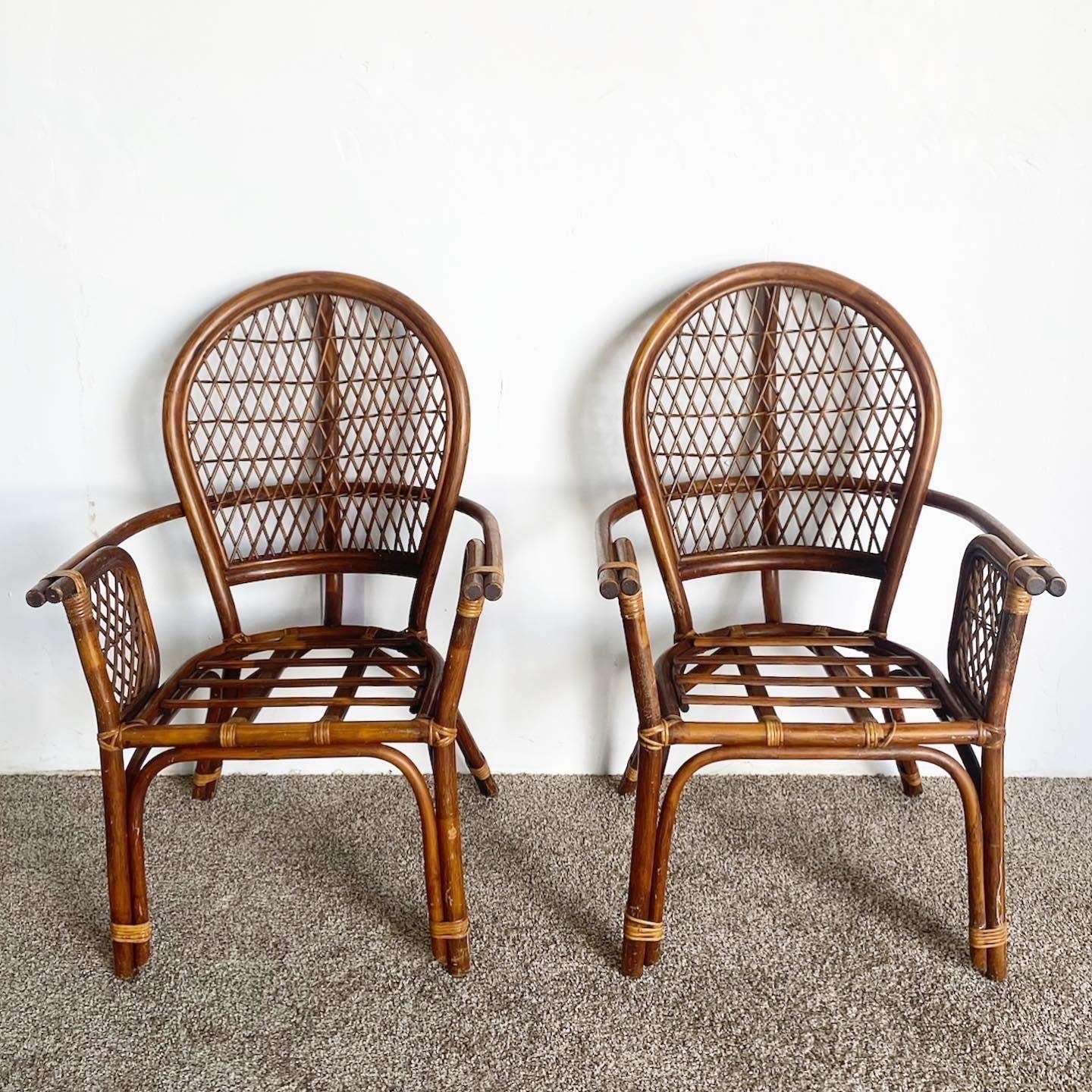 Wonderful set of 4 vintage bohemian bamboo rattan arm chairs. Each feature a balloon back with latticed sides and back rests. 