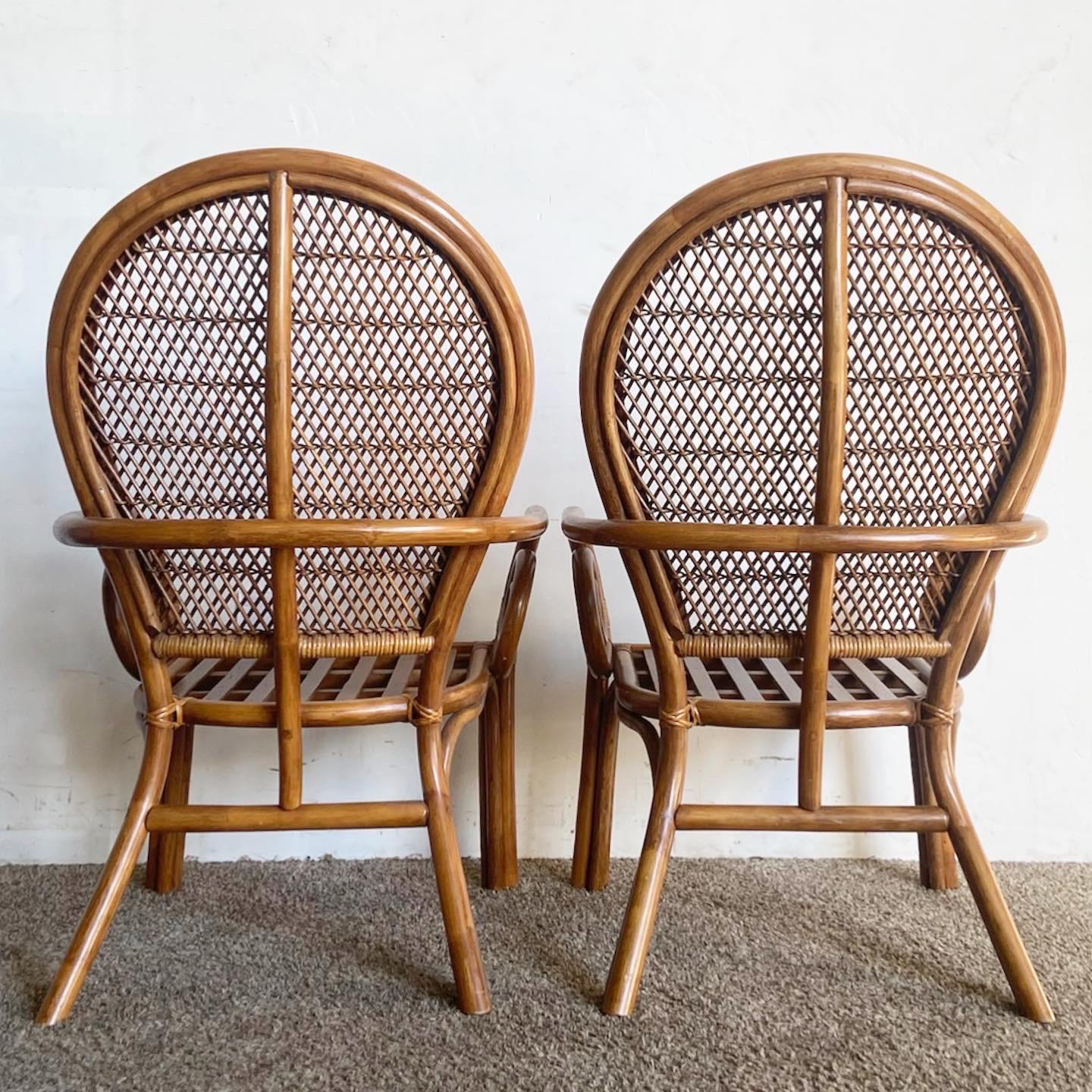Experience relaxed elegance with these Boho Chic Bamboo Rattan Balloon Back Swirl Arm Chairs. Intricately woven rattan meets artistic swirl armrests for a chair that offers both style and comfort. Perfect for dining or cozy reading nooks, these