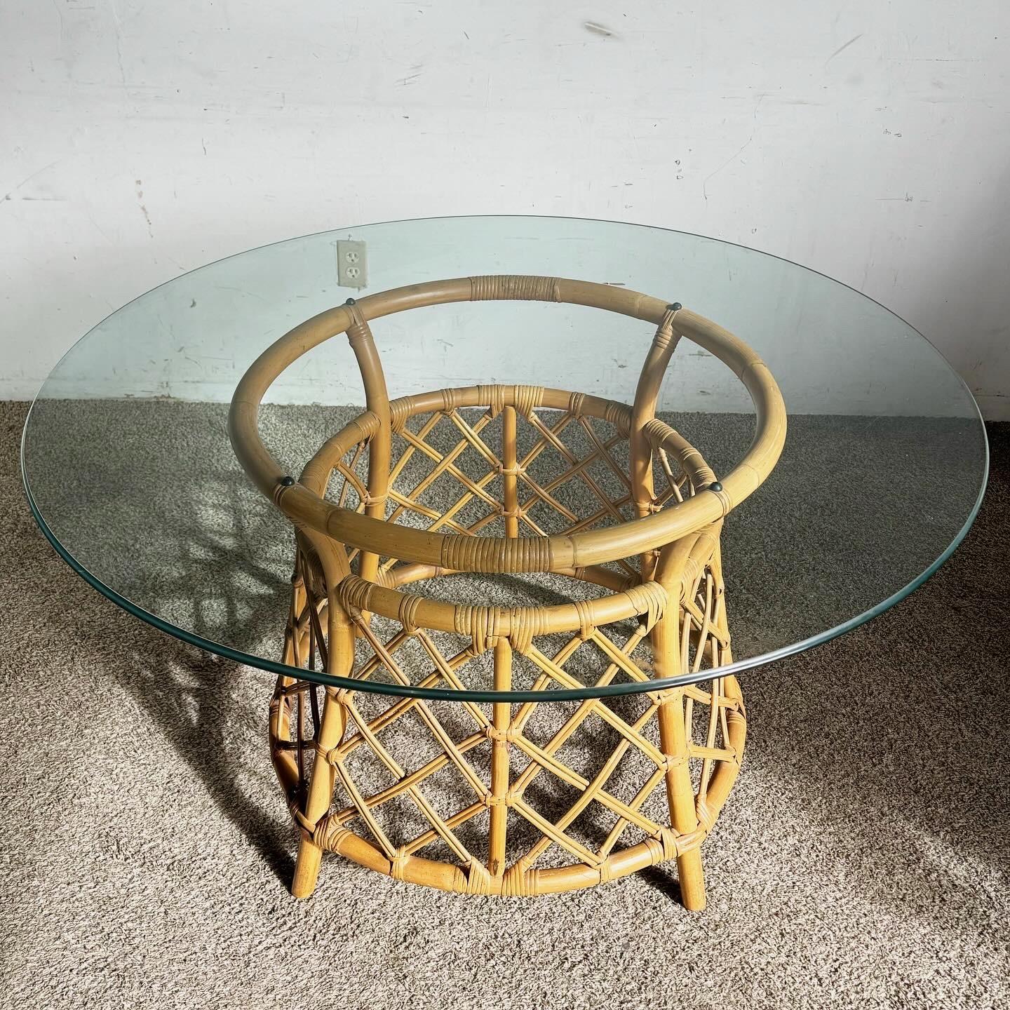 Elevate your dining experience with the Boho Chic Bamboo Rattan Circular Glass Top Dining Table by Ficks Reed. This table features a skillfully crafted bamboo and rattan base, paired with a durable circular glass top. Ideal for those who appreciate