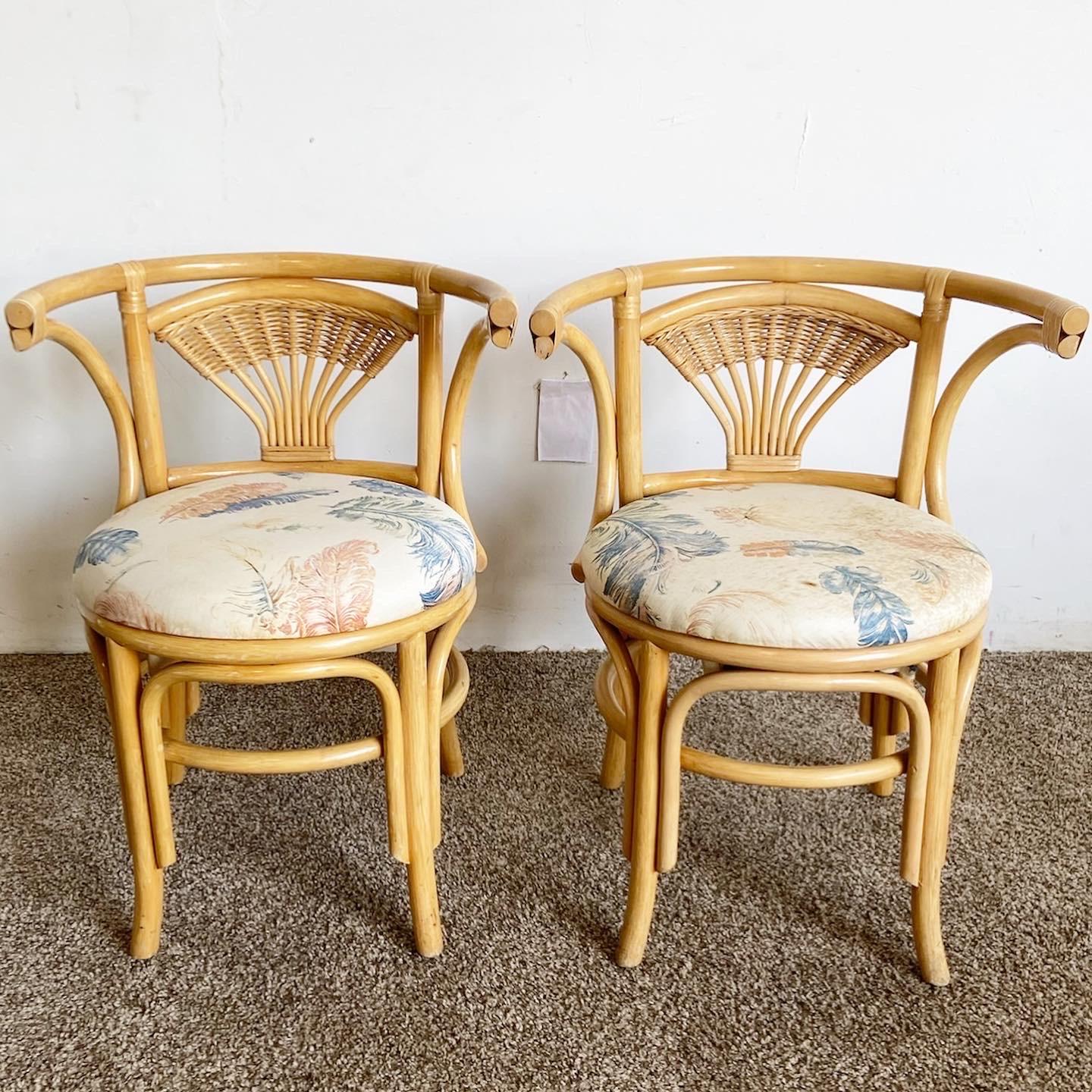 Exceptional vintage boho chic bamboo rattan nesting dining set. Features an oval inlaid glass top with the chairs which snuggle flush beneath the table


Table measures 41”W, 22”D, 29”H.