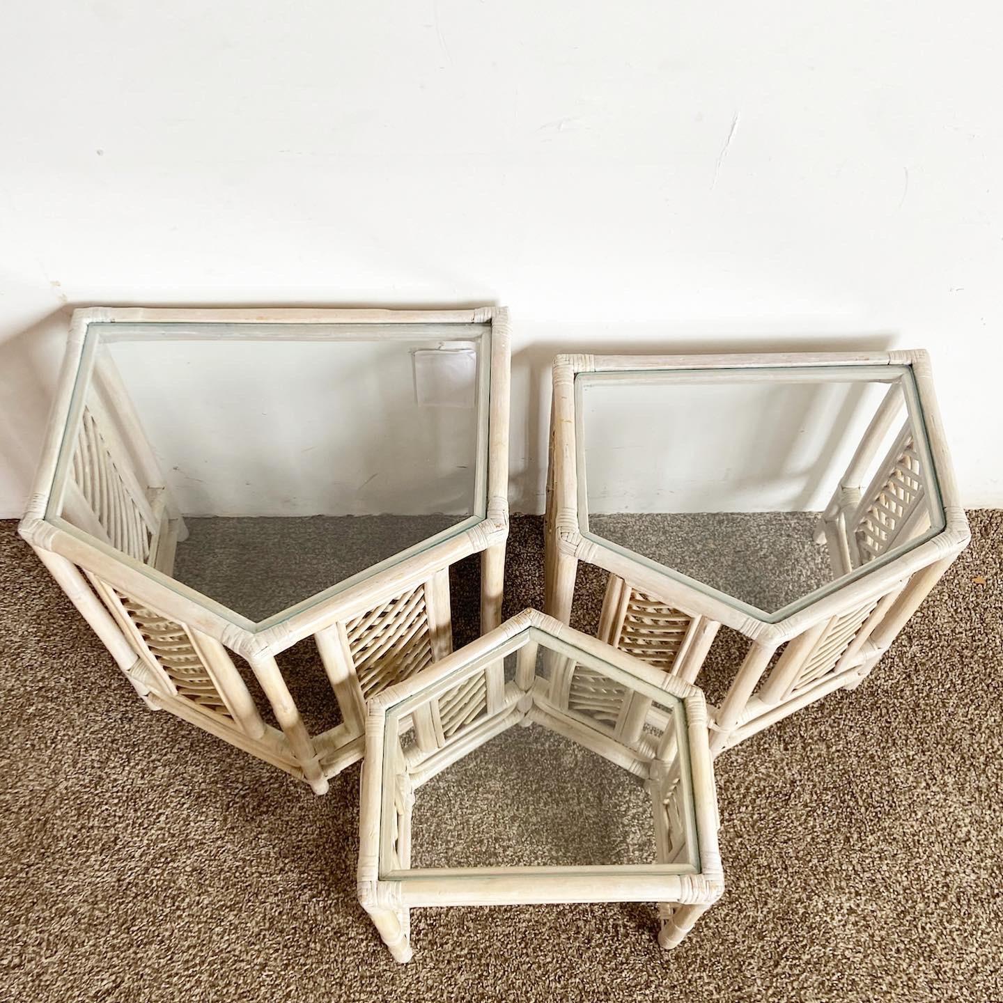 Elevate your living space with this set of 3 Boho Chic Bamboo Rattan Nesting Tables. Featuring a white-washed finish and 