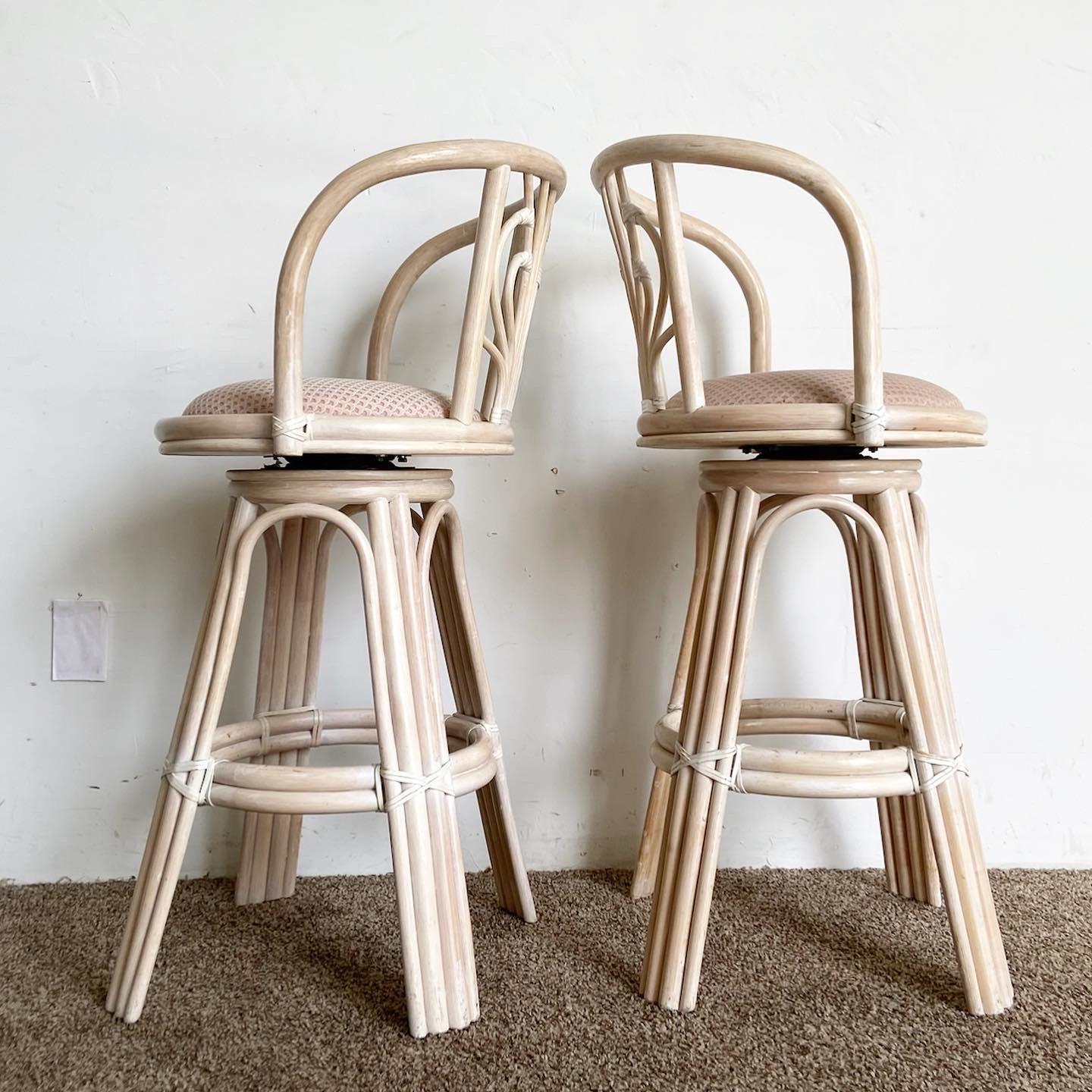 Experience the allure of boho chic with this remarkable set of 4 vintage bamboo rattan swivel counter stools. Each stool boasts a delightful washed pickled pink finish, perfectly complemented by sculpted backrests. Elevate your space with style and