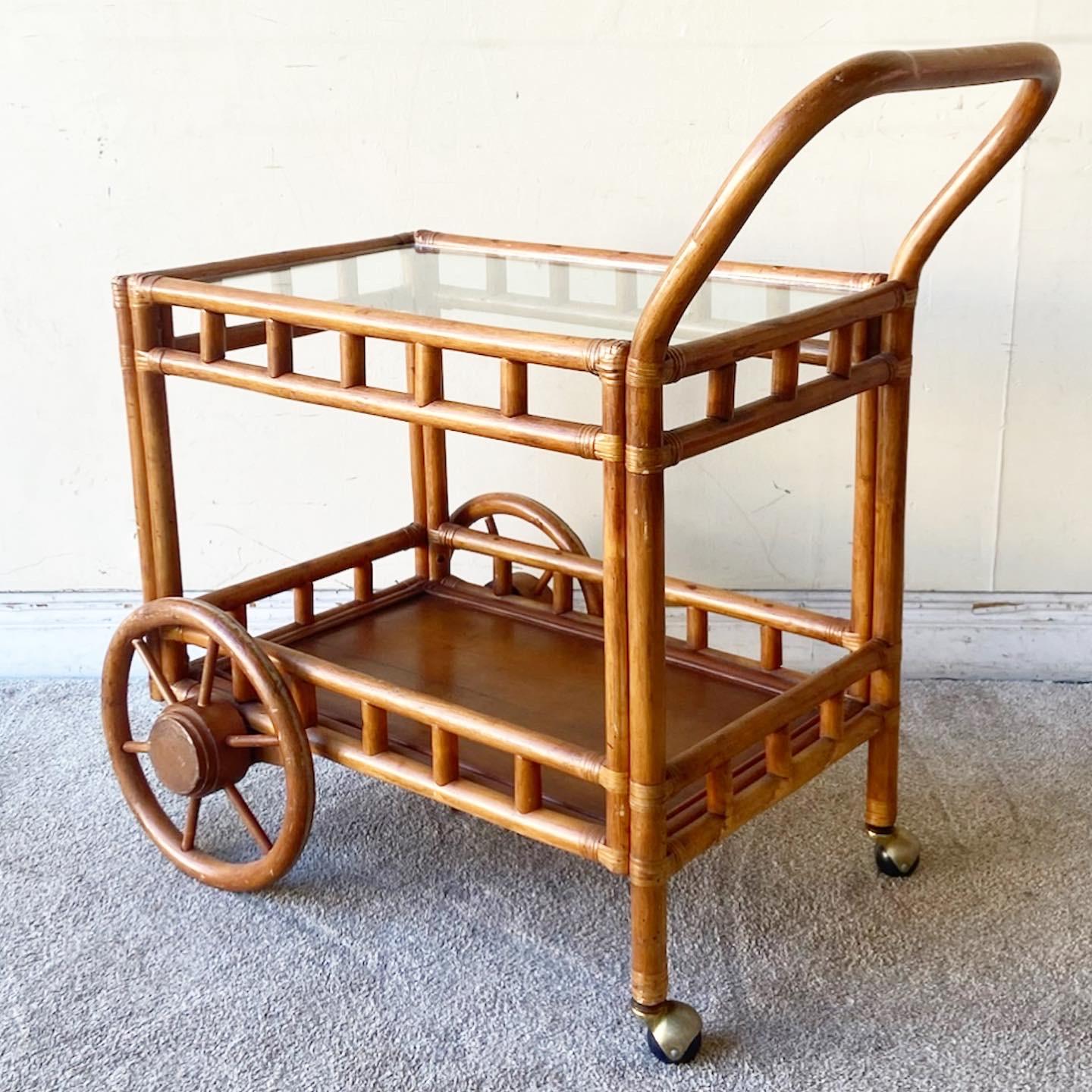Incredible vintage bohemian wagon bar cart. Feature a bamboo frame with rattan jointing with a glass top tier and wooden lower tier.