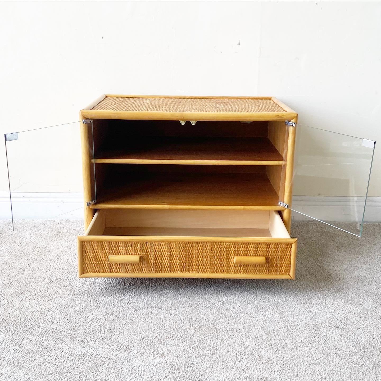 Amazing bamboo wicker cabinet cart with one drawer and a two shelf glass cabinet. Cabinet cart glides smoothly on spherical wheels.

Additional Information:
Material: Wicker, Wood
Color: Brown
Style: Boho Chic
Time Period: 1980s
Dimension: