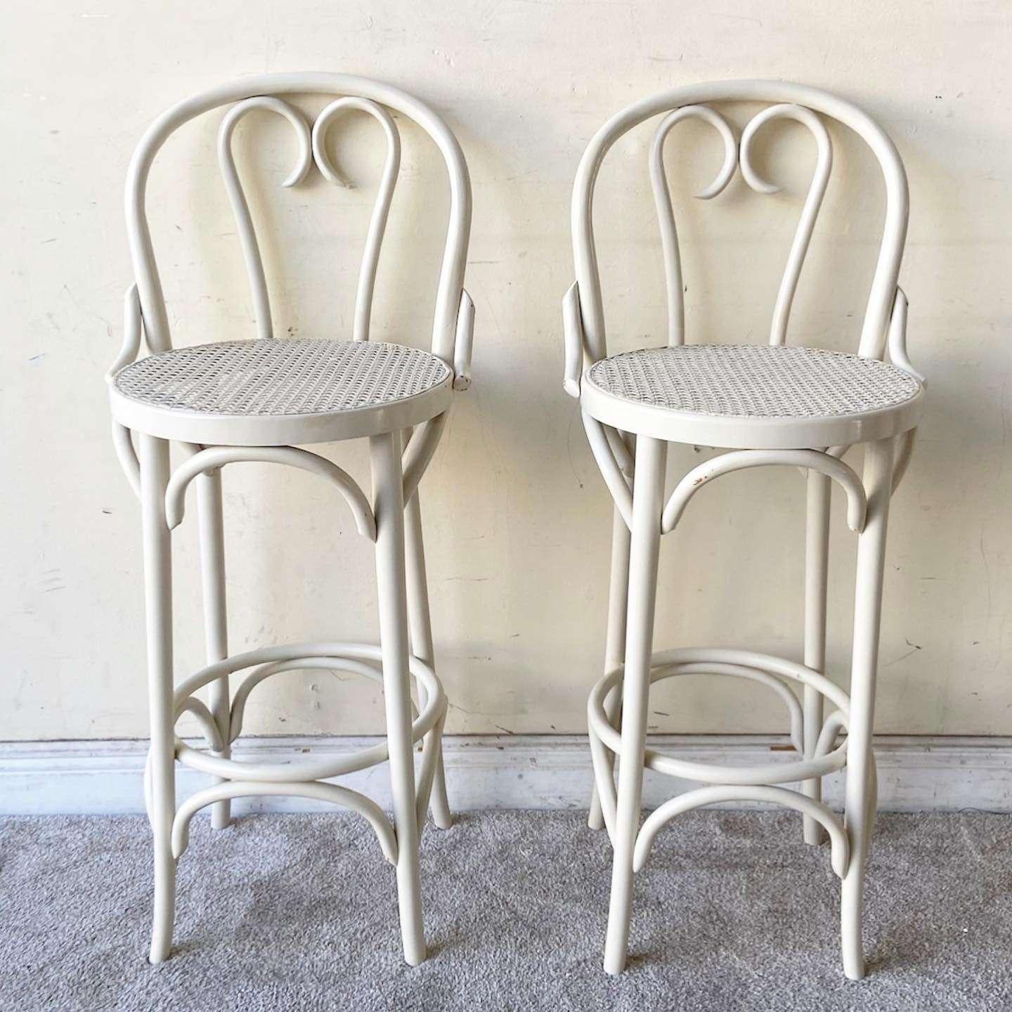 Amazing. Set of 4 vintage bohemian bent wood thonet stools. Each features a cane seat with an off white finish.

Seat height is 29.5 in