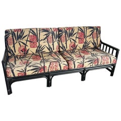 Boho Chic Black Wicker Rattan Sofa With Tan Red and Black Cushions