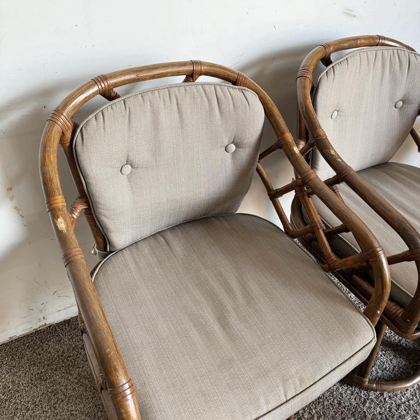 Explore the fusion of bohemian elegance and traditional craftsmanship with this set of 4 Boho Chic Chippendale Style Bamboo Rattan Swivel Arm Dining Chairs. These chairs blend the intricate Chippendale design with the natural charm of bamboo and