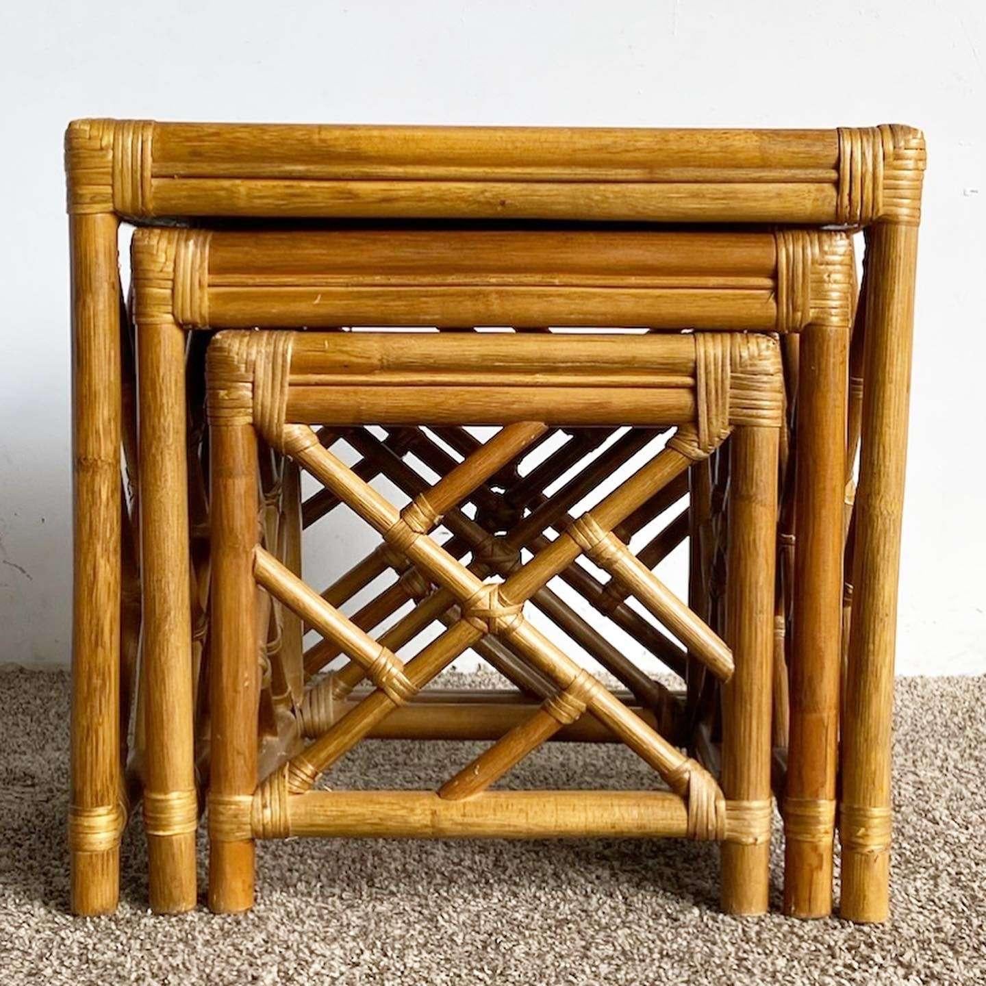 Amazing vintage boho chic Chippendale style nesting tables. Each feature a bamboo construction with rattan jointing and wicker tops.

Medium table measures 19”W, 14.5”D, 18.5”H
Small table measures 15.25”W, 12.75”D, 16”H