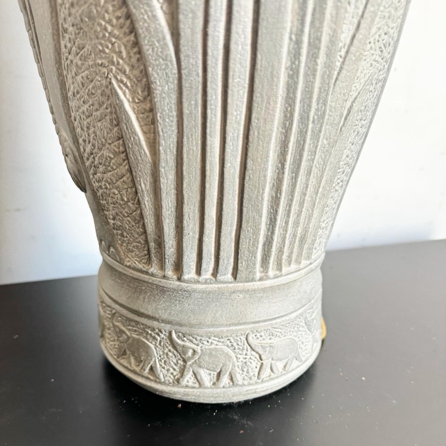 Embrace the wild allure of this Boho Chic Elephant Etched Ceramic Table Lamp. Featuring intricate elephant etchings on a textured ceramic base, this lamp brings a touch of Bohemian flair and cultural charm to any space. The fabric shade enhances its