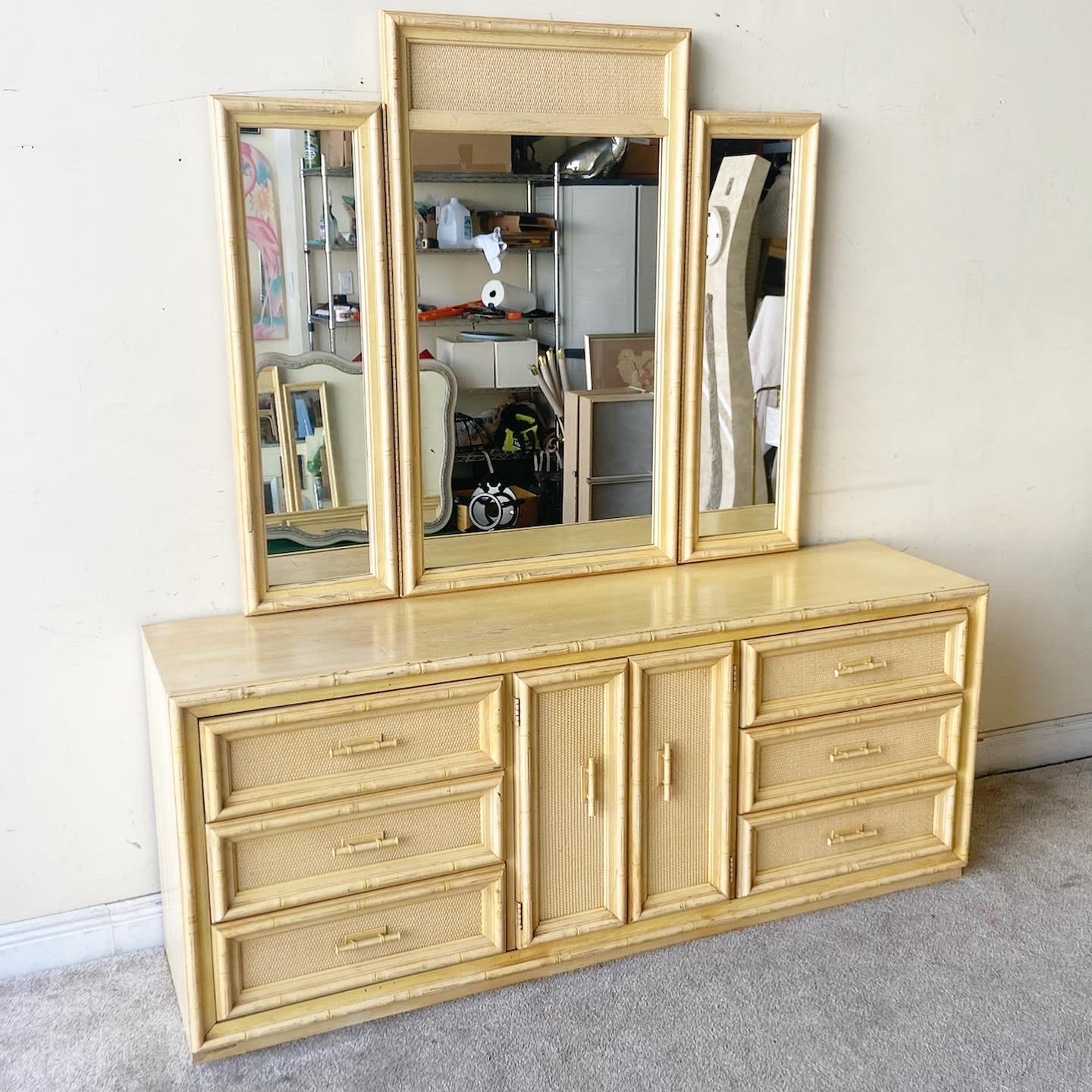Exceptional vintage bohemian dresser with matching triple mirror. Features a cream/light yellow finish with faux bamboo framing and drawer pulls.

Mirror measures 55” W, 1.5” D, 48” H.