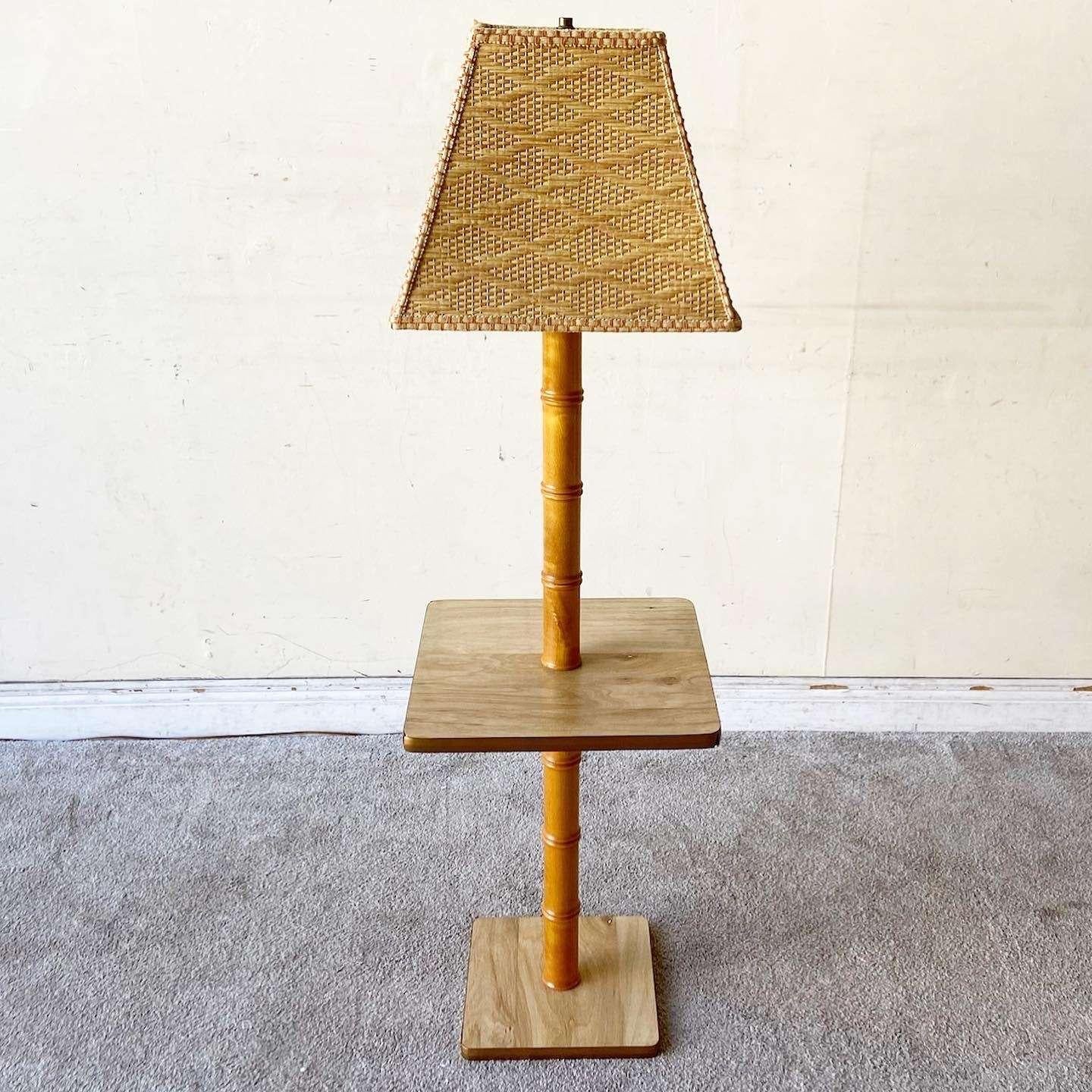 Exceptional vintage bohemian floor lamp/side table. Features a faux bamboo stem with a Woodgrain laminate table and woven lamp shade.
