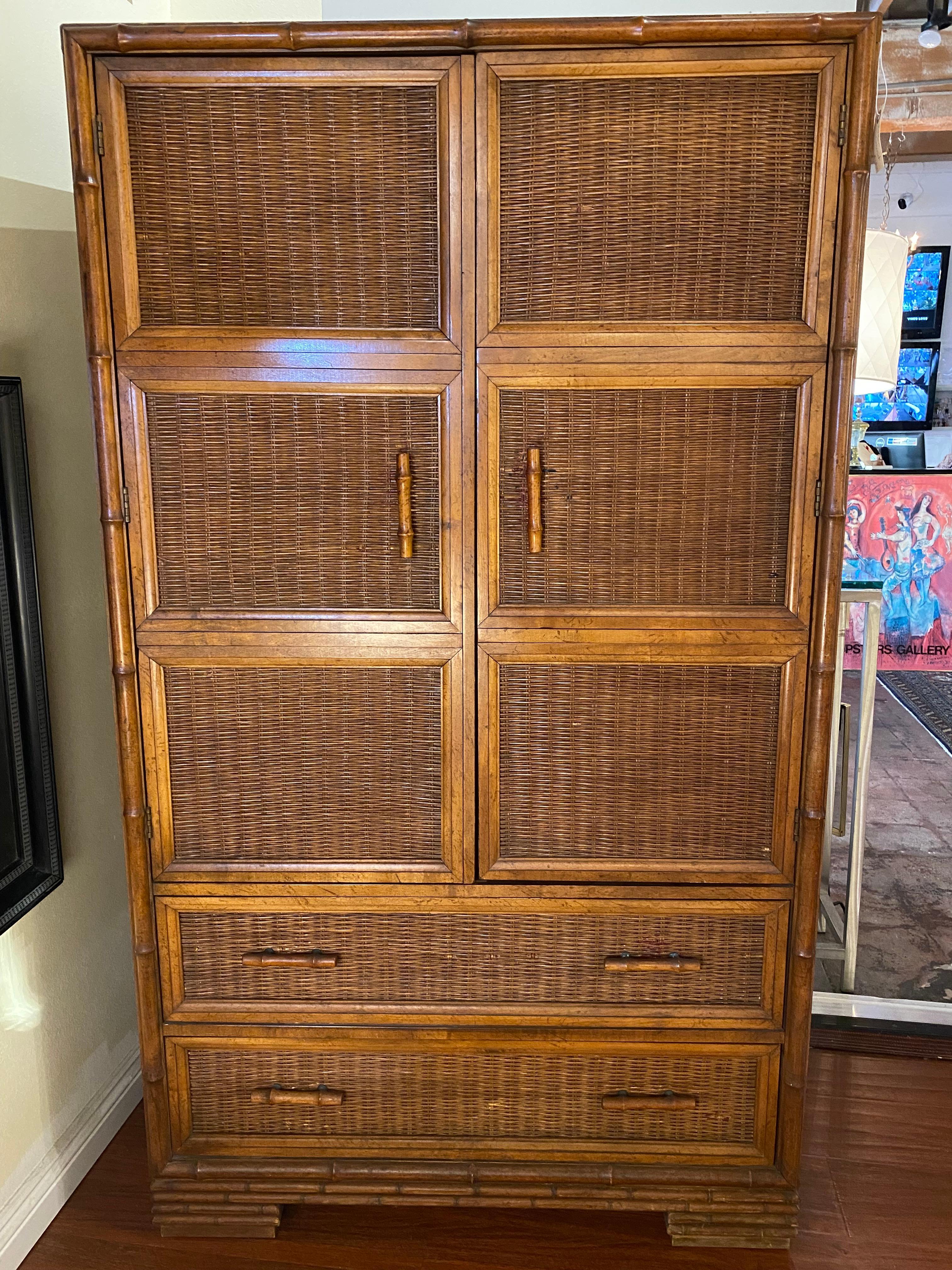 This Boho Chic faux bamboo wicker armoire by American of Martinsville is made in faux bamboo and wicker with elegant lines and brass knobs inside.  This wardrobe cabinet features a woven wicker front, accented with faux bamboo framing for a natural,