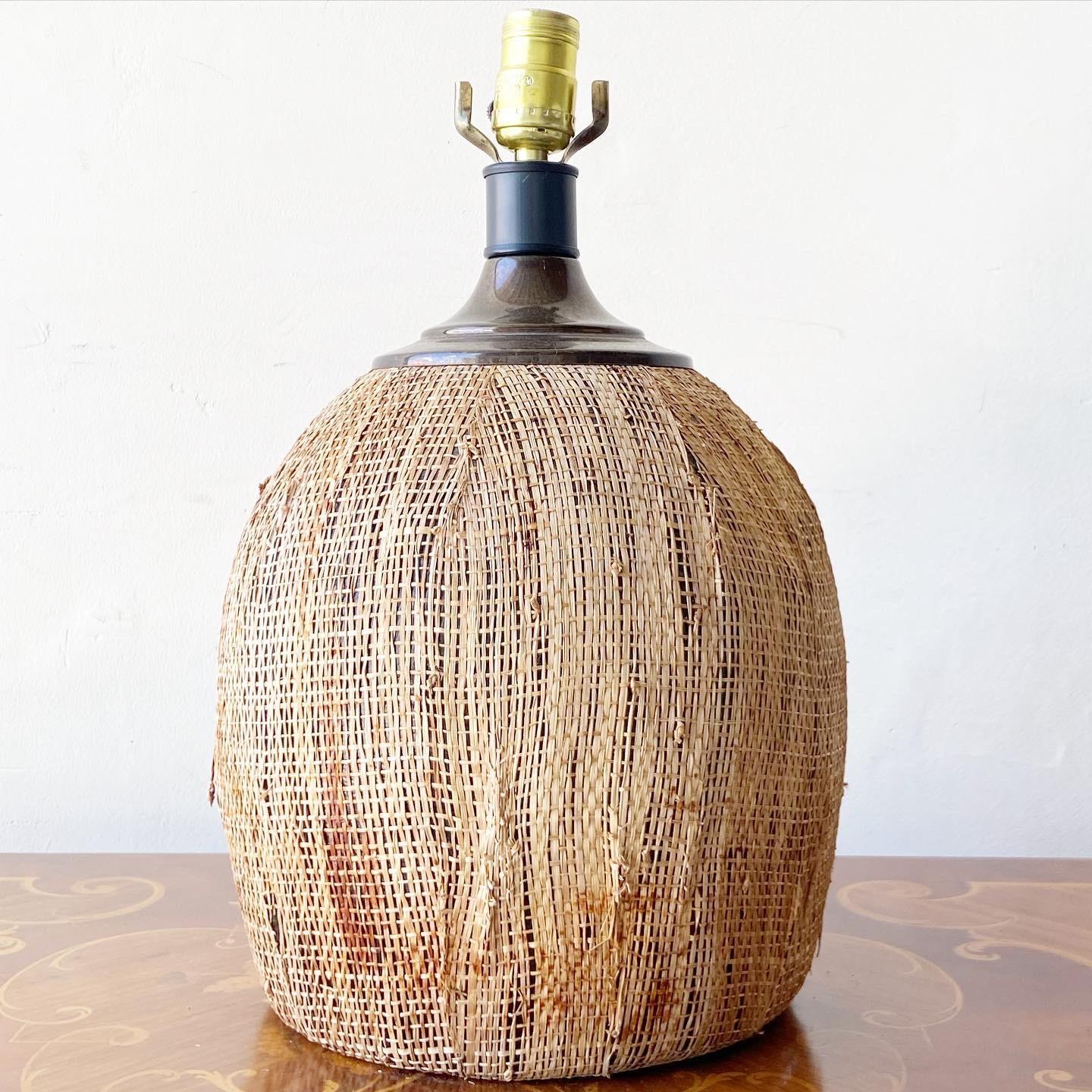 Exceptional vintage bohemian table lamps. Features a grass cloth wrapped body giving resemblance of a coconut.

3 way lighting.