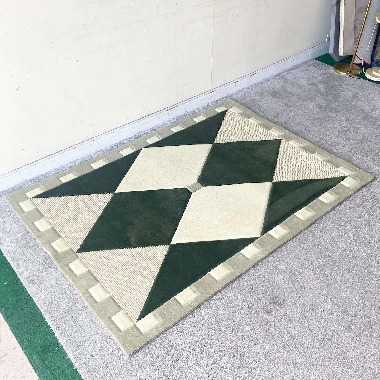 Exceptional vintage boho chic rectangular area rug. The interior displays cream, dark green and woven diamonds and triangles. Th outer edge is a light green with cream rectangles throughout.

Rug 35
