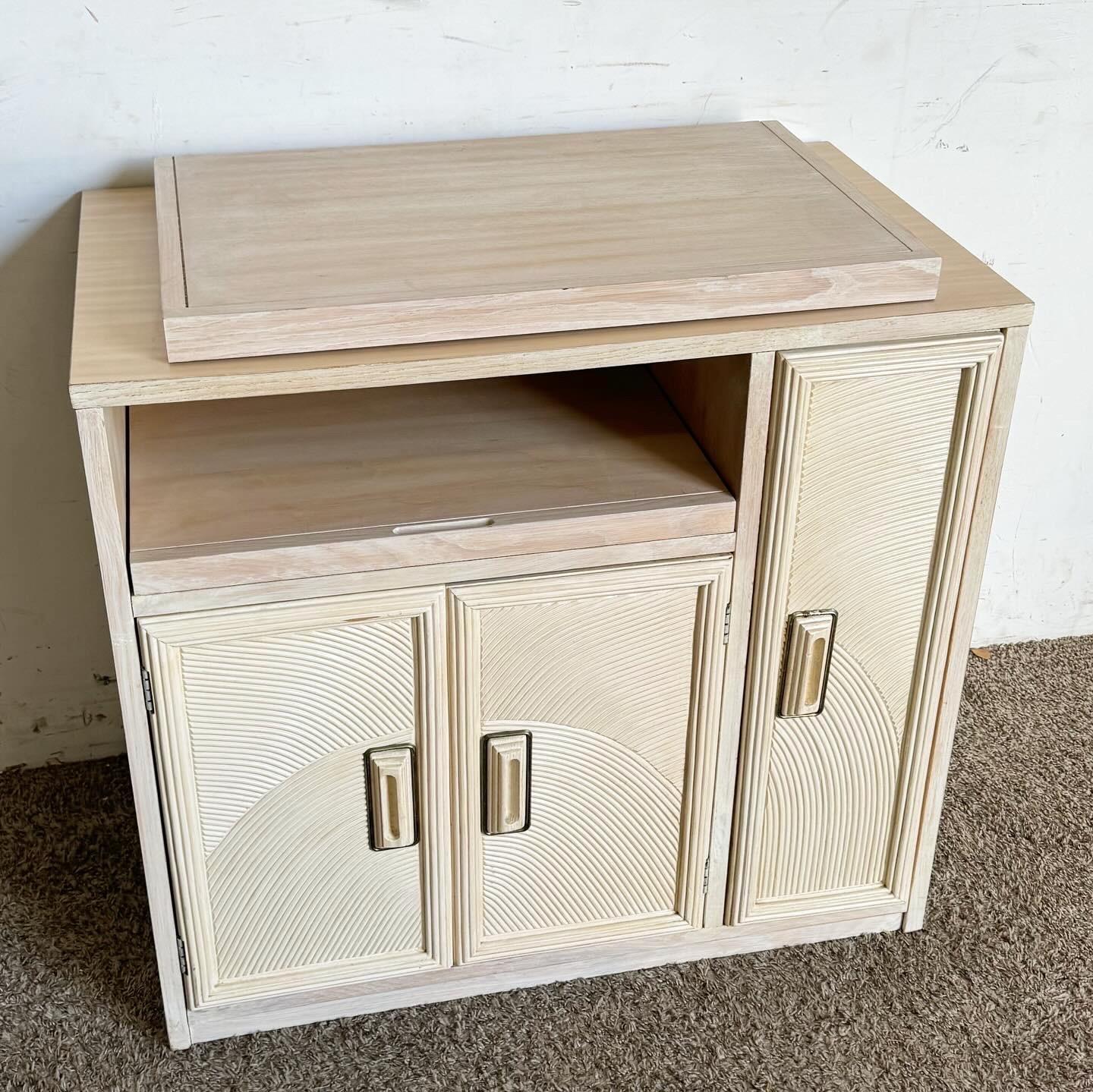 Elevate your entertaining space with this Boho Chic Henry Link Pencil Reed Dry Bar. Featuring a unique rotating top and crafted in the 1980s, this piece offers both style and functionality. The textured pencil reed design adds natural elegance,